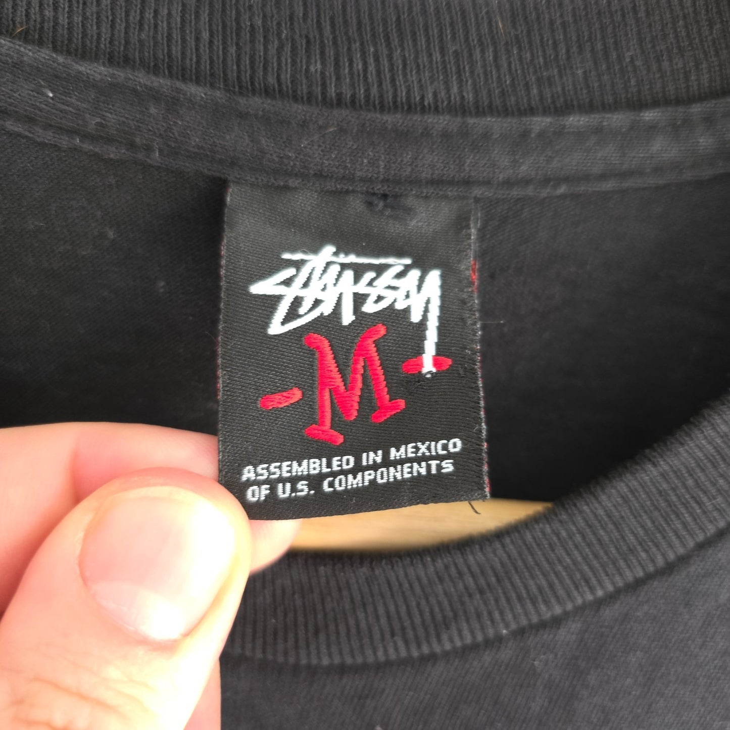 Stüssy black comic graphic t-shirt featuring large "Shout! Smash!" print, cotton material.