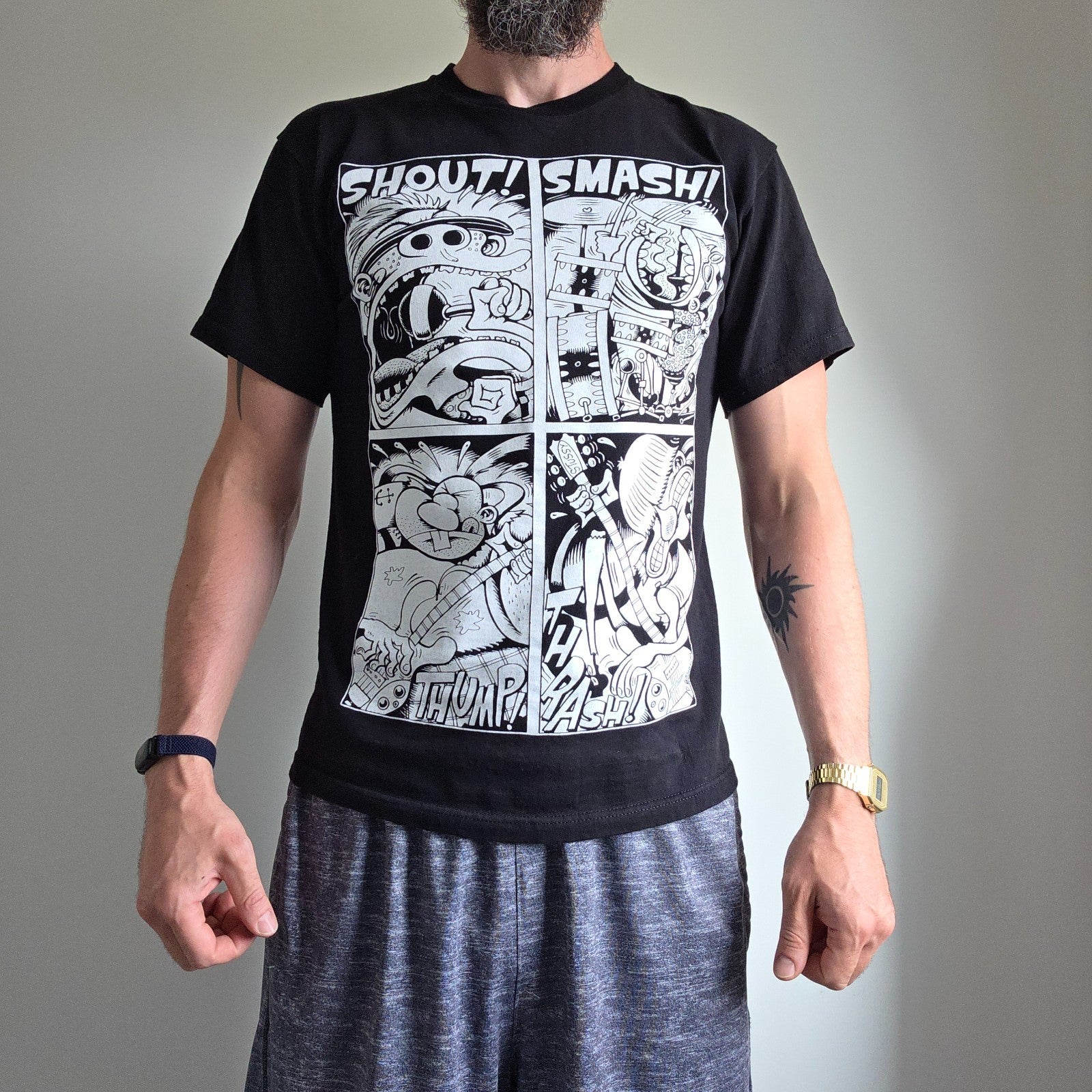 Stüssy black comic graphic t-shirt featuring large "Shout! Smash!" print, cotton material.