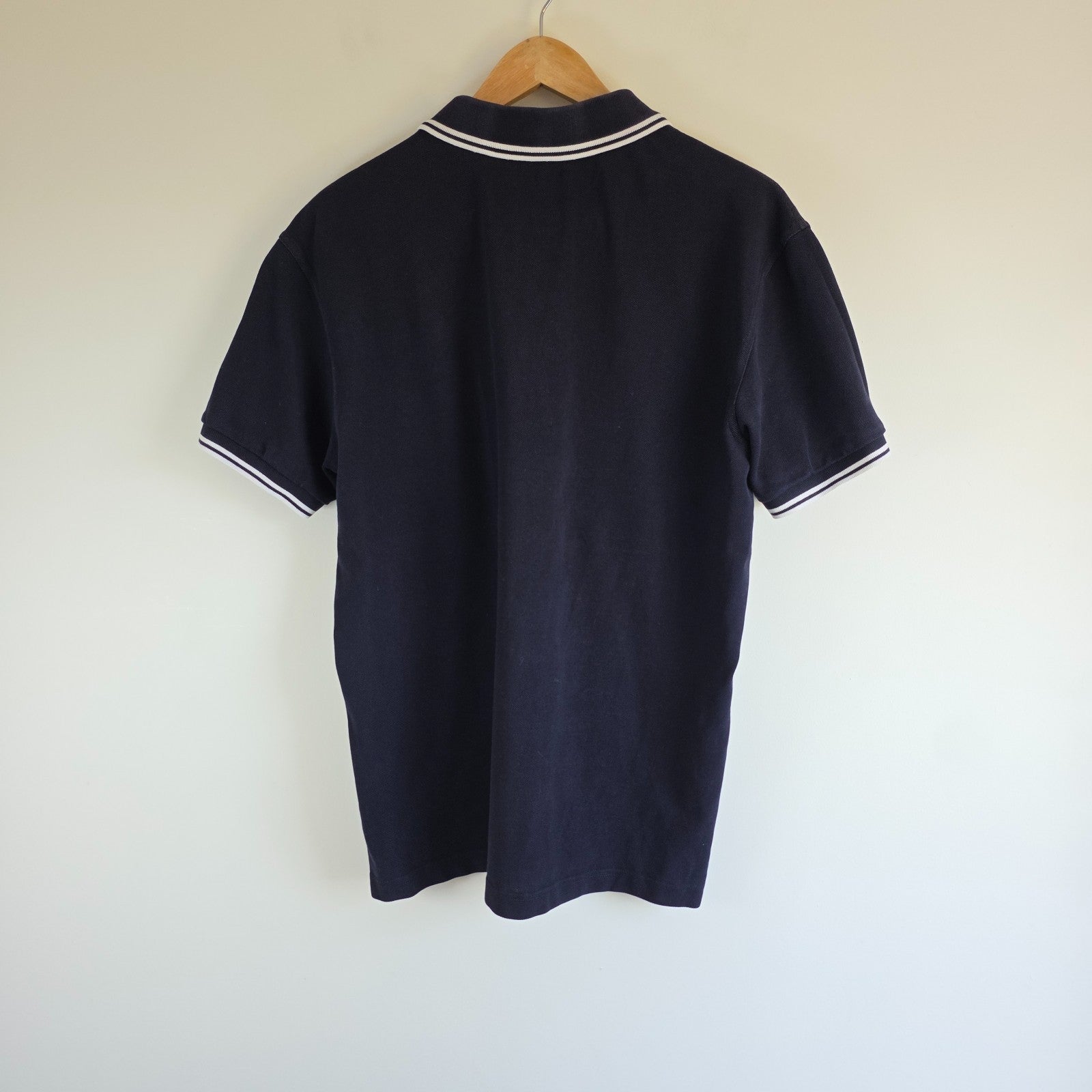 Fred Perry navy blue polo shirt with twin tipped collar and cotton material.