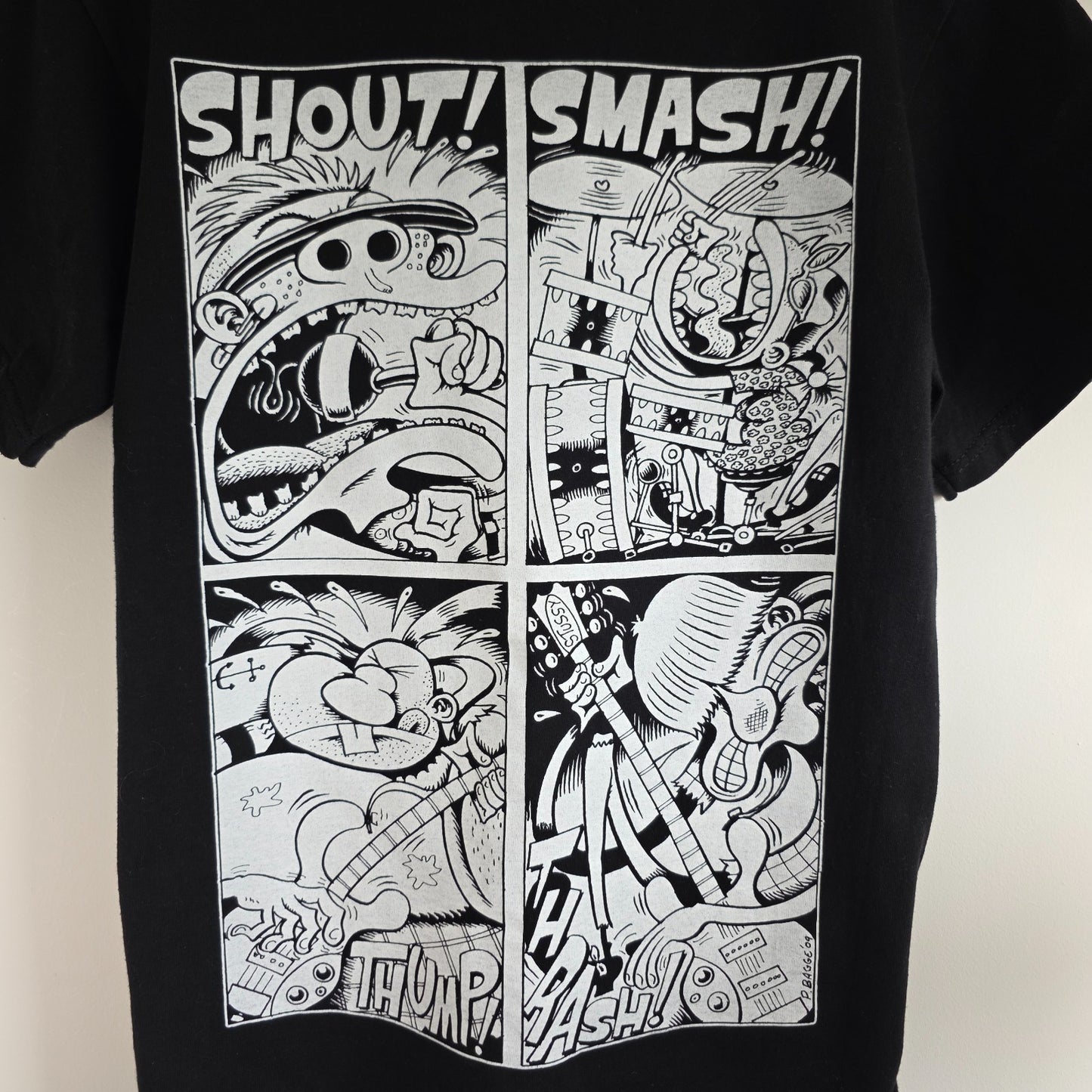 Stüssy black comic graphic t-shirt featuring large "Shout! Smash!" print, cotton material.