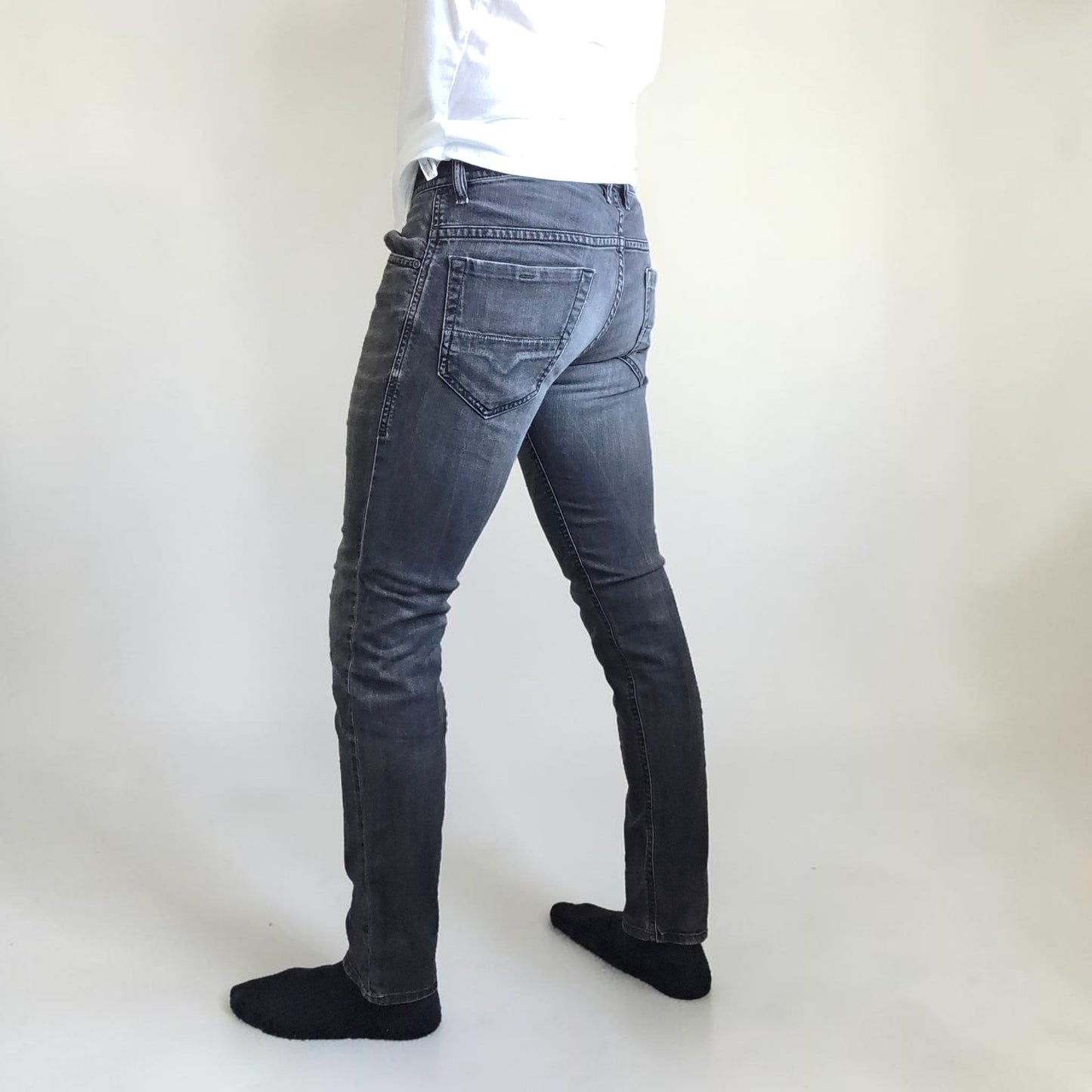 Diesel black straight jeans with grey wash, stretch denim, and branded tag.