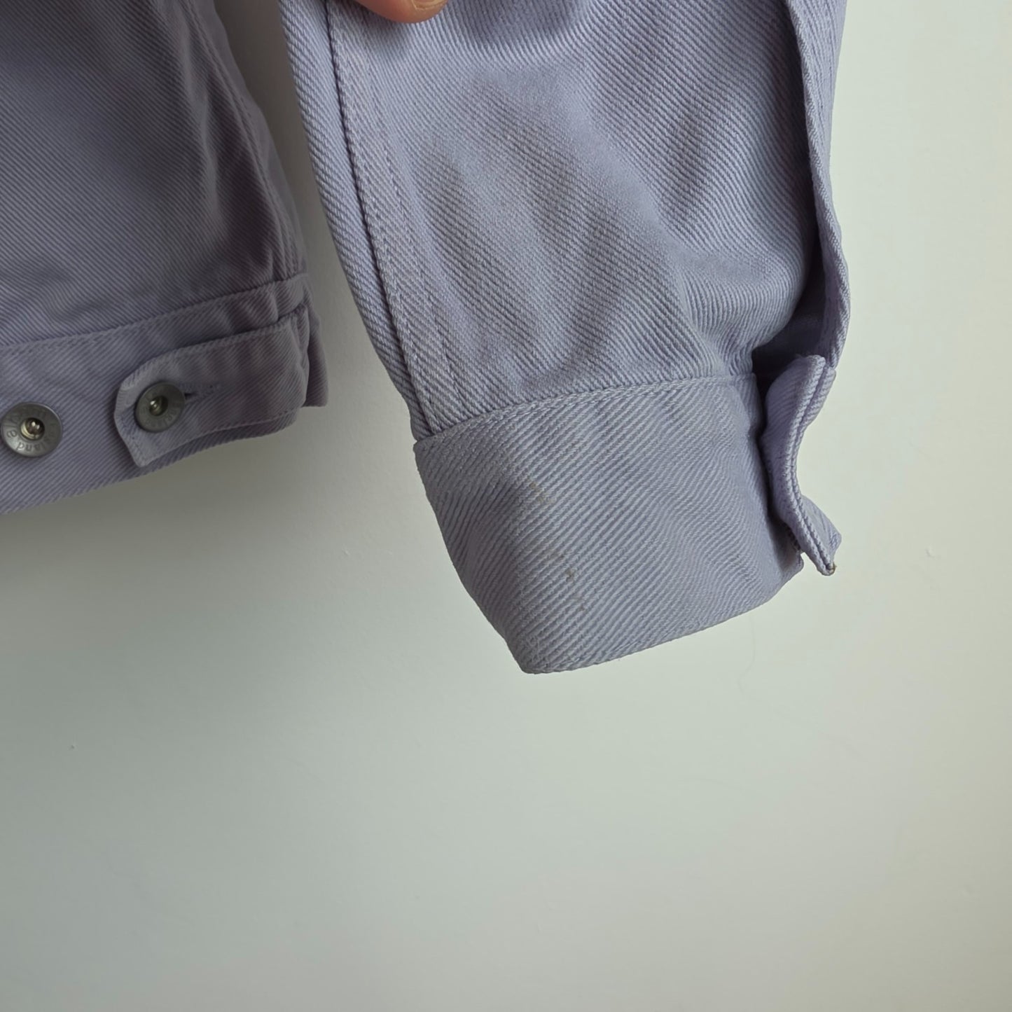 Albam lilac denim jacket with button front, chest pockets, and side pockets.