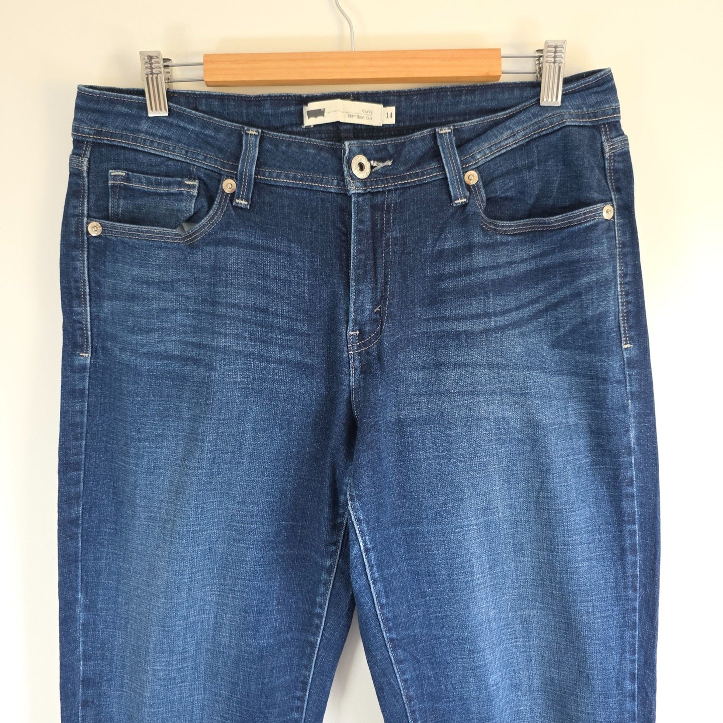 Levi's blue straight jeans with distressed details and classic 501 logo.