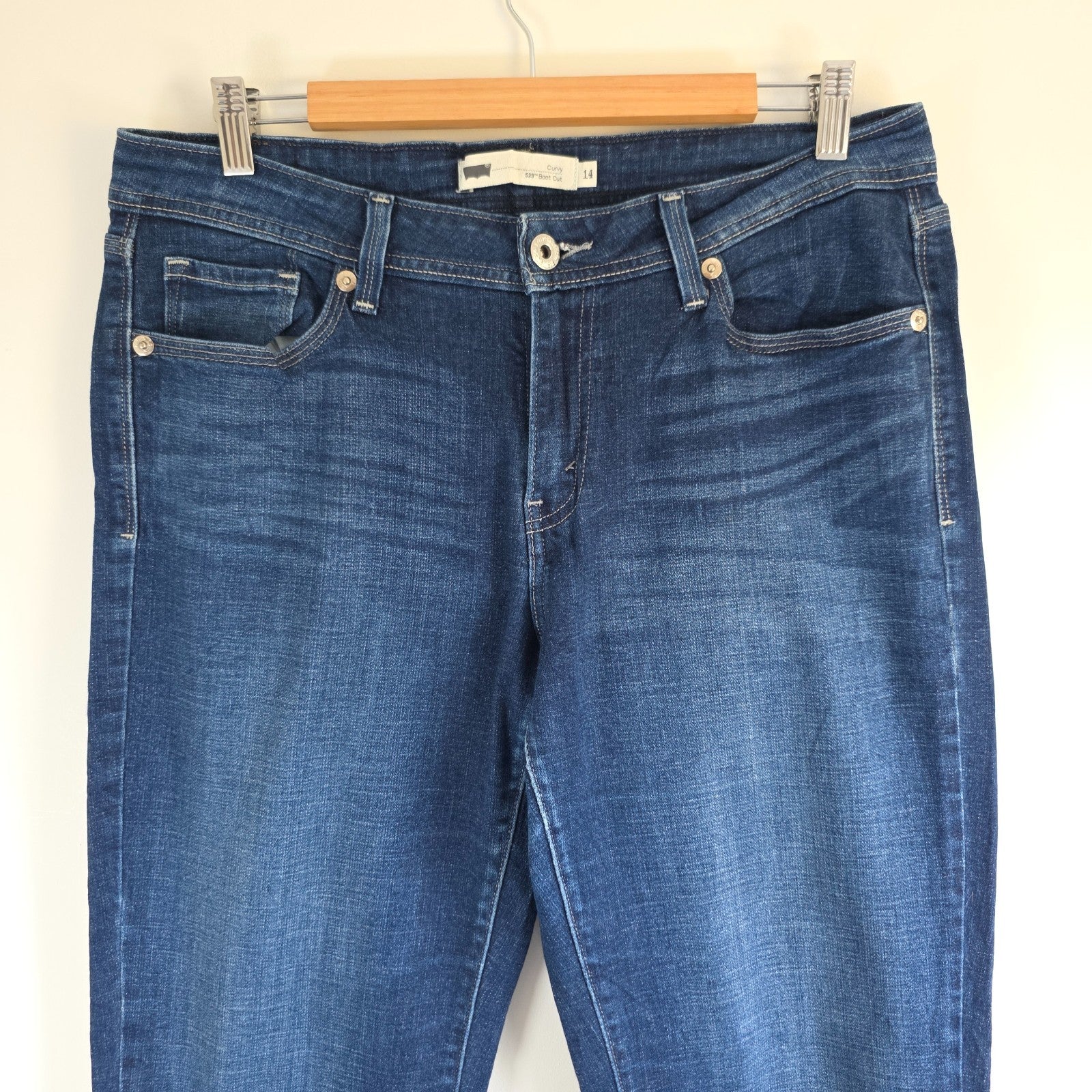 Levi's blue straight jeans with distressed details and classic 501 logo.