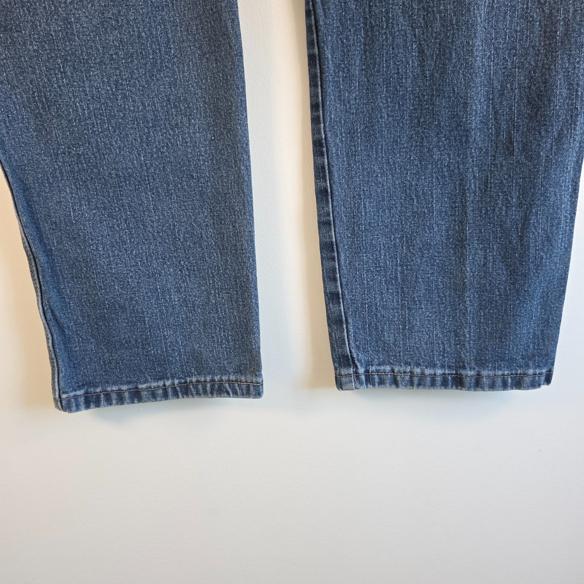 Wrangler blue carpenter jeans with distressed detailing, utility pockets, and hammer loop.
