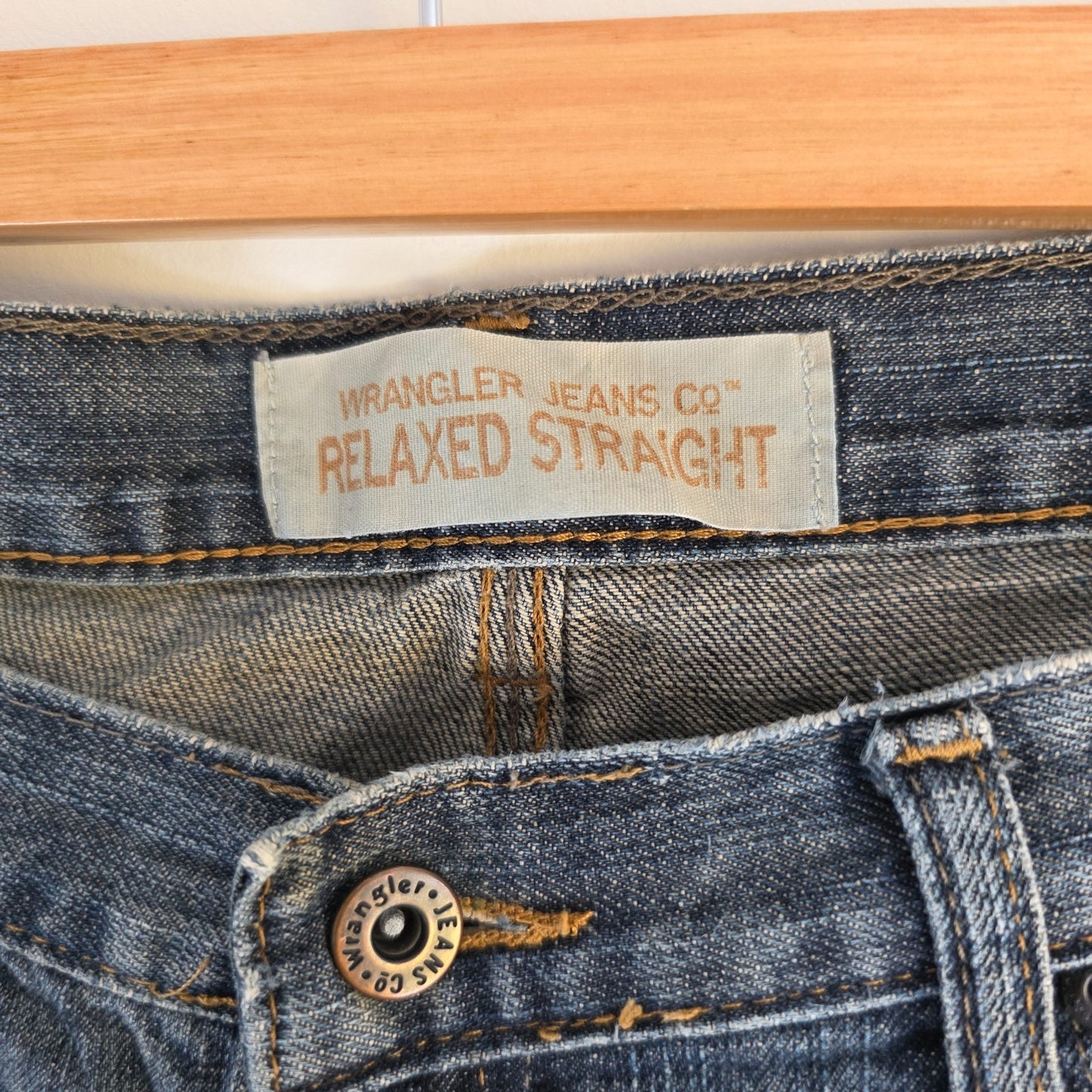 Wrangler blue straight jeans with relaxed fit, 100% cotton, professional hemmed to 30 inches.