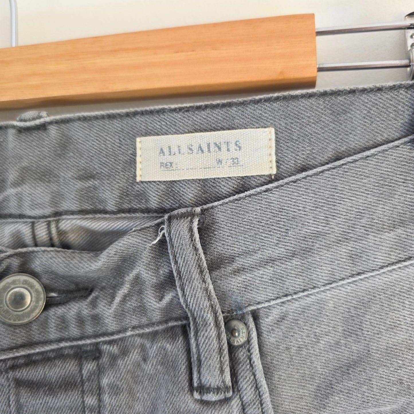 AllSaints grey slim jeans with button fly and stretch cotton elastane blend.