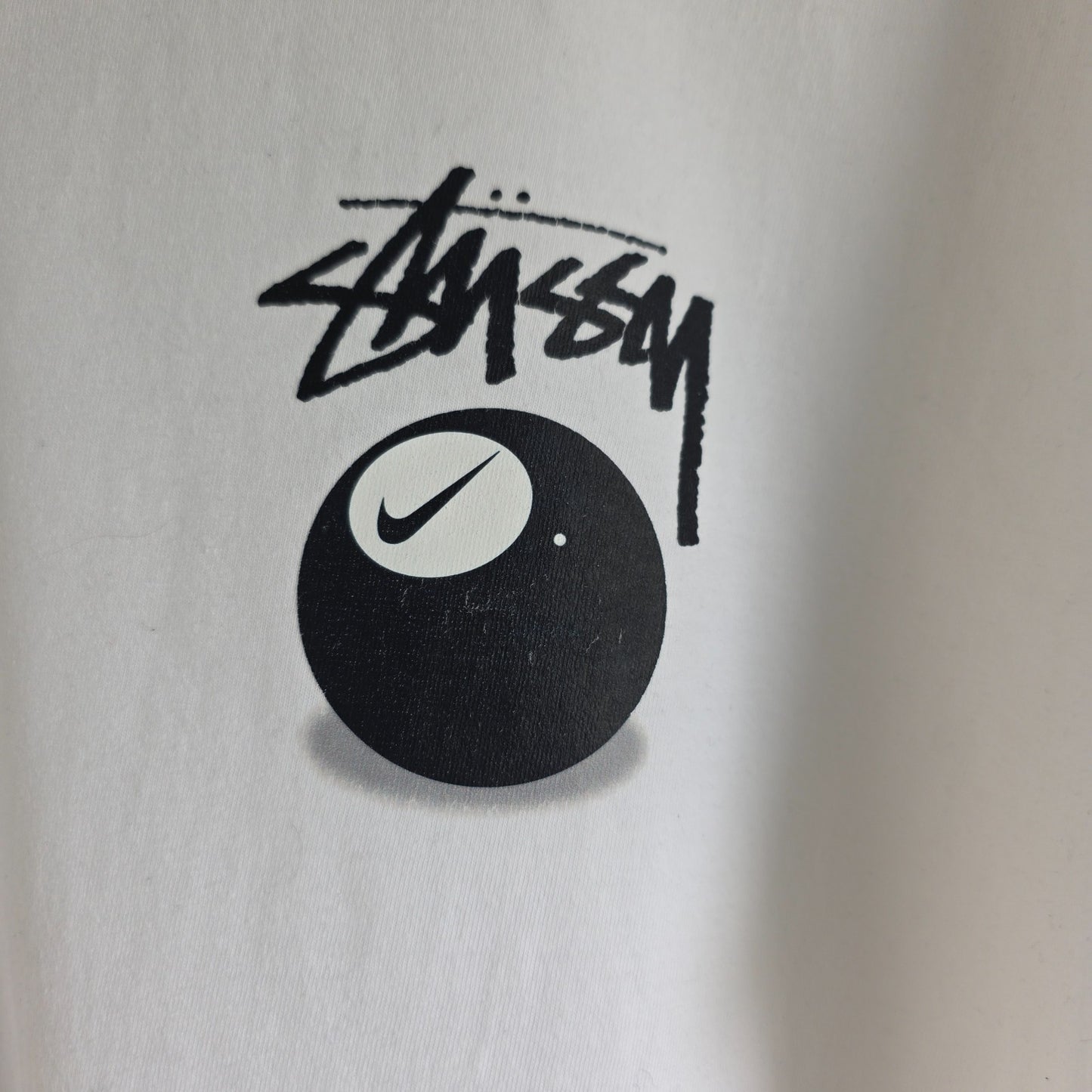 Stüssy x Nike white t-shirt with large 8 Ball back print and cotton material.