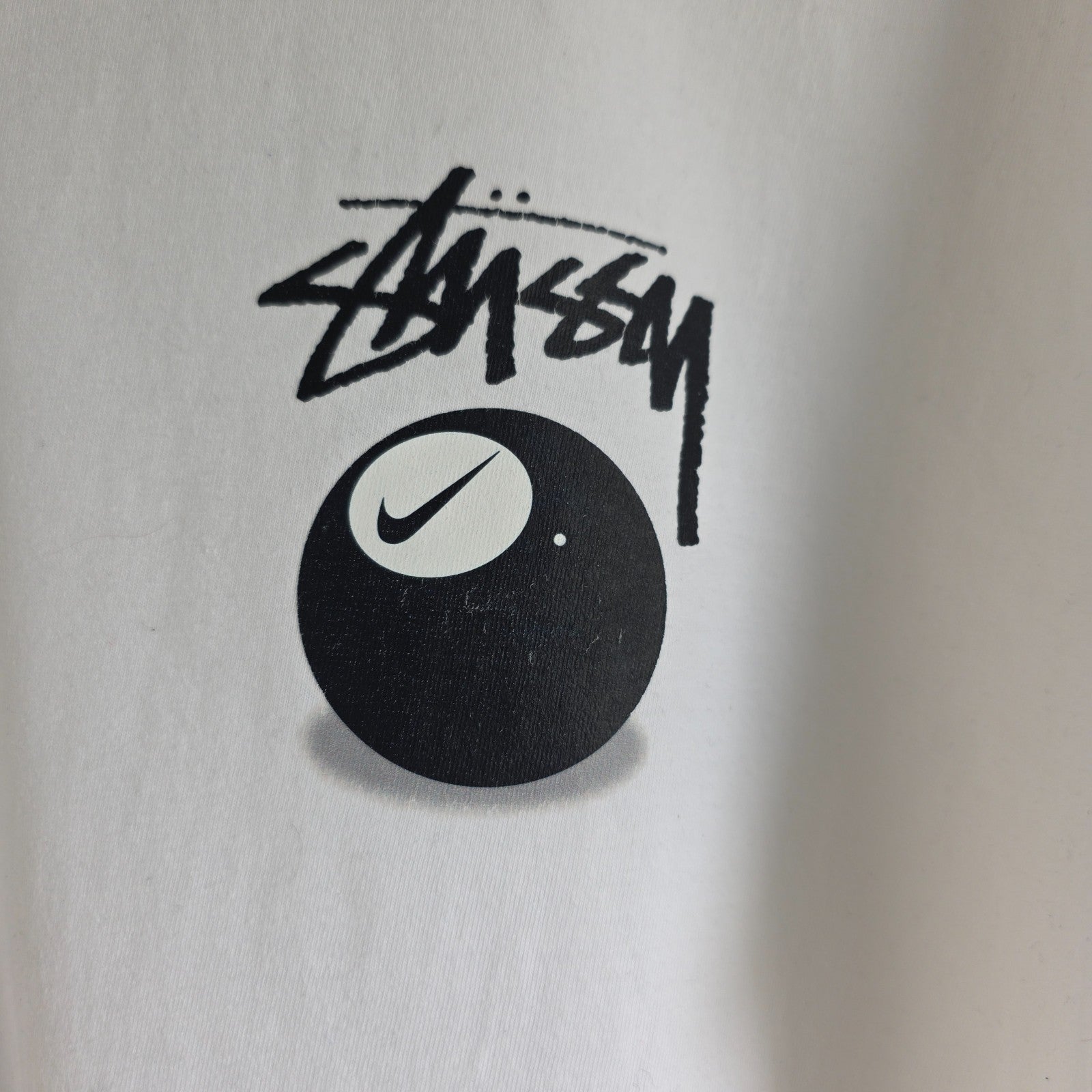 Stüssy x Nike white t-shirt with large 8 Ball back print and cotton material.