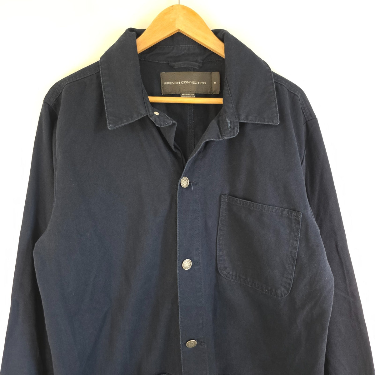 French Connection blue chore jacket with three patch pockets and metal button fastening.