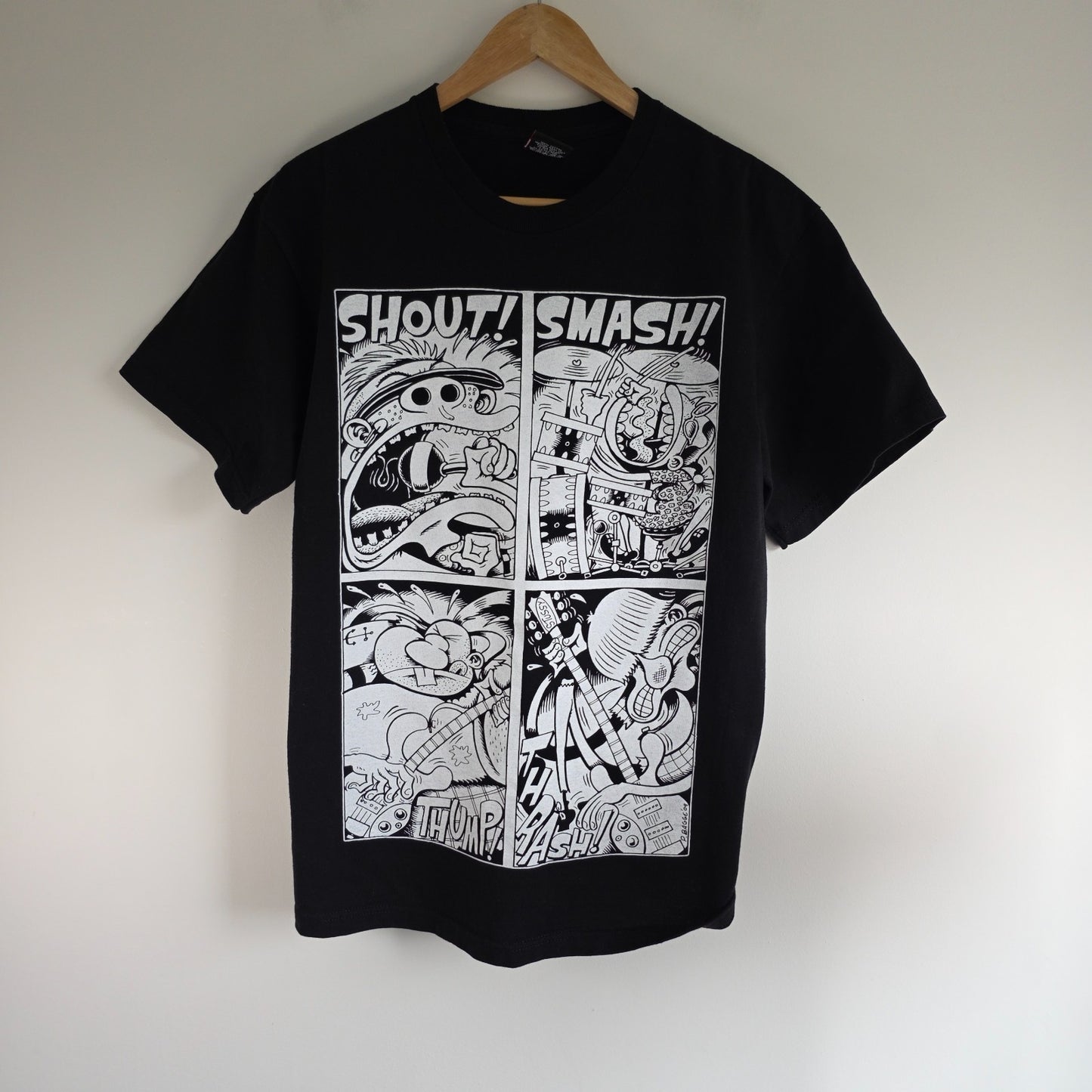 Stüssy black comic graphic t-shirt featuring large "Shout! Smash!" print, cotton material.