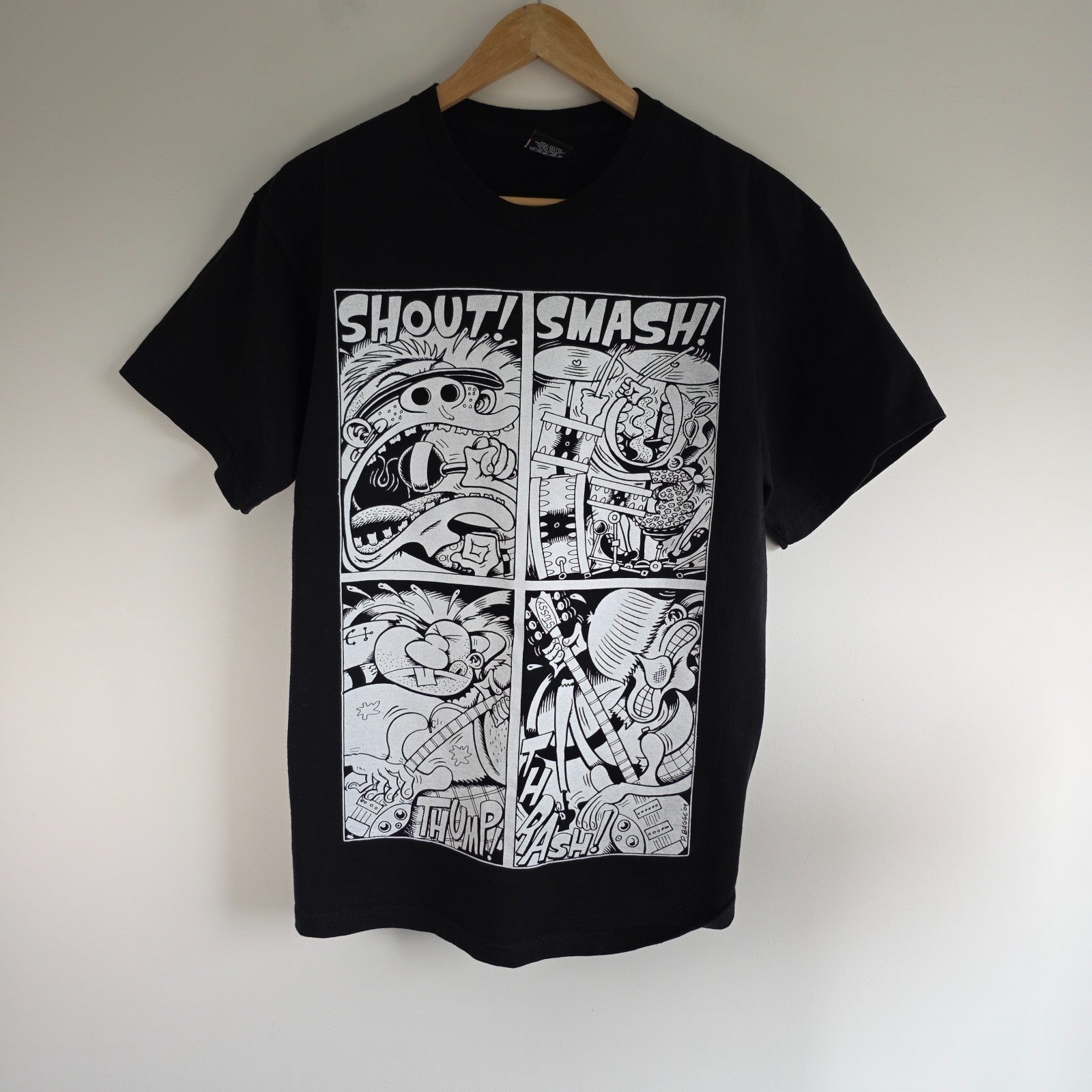 Stüssy black comic graphic t-shirt featuring large "Shout! Smash!" print, cotton material.