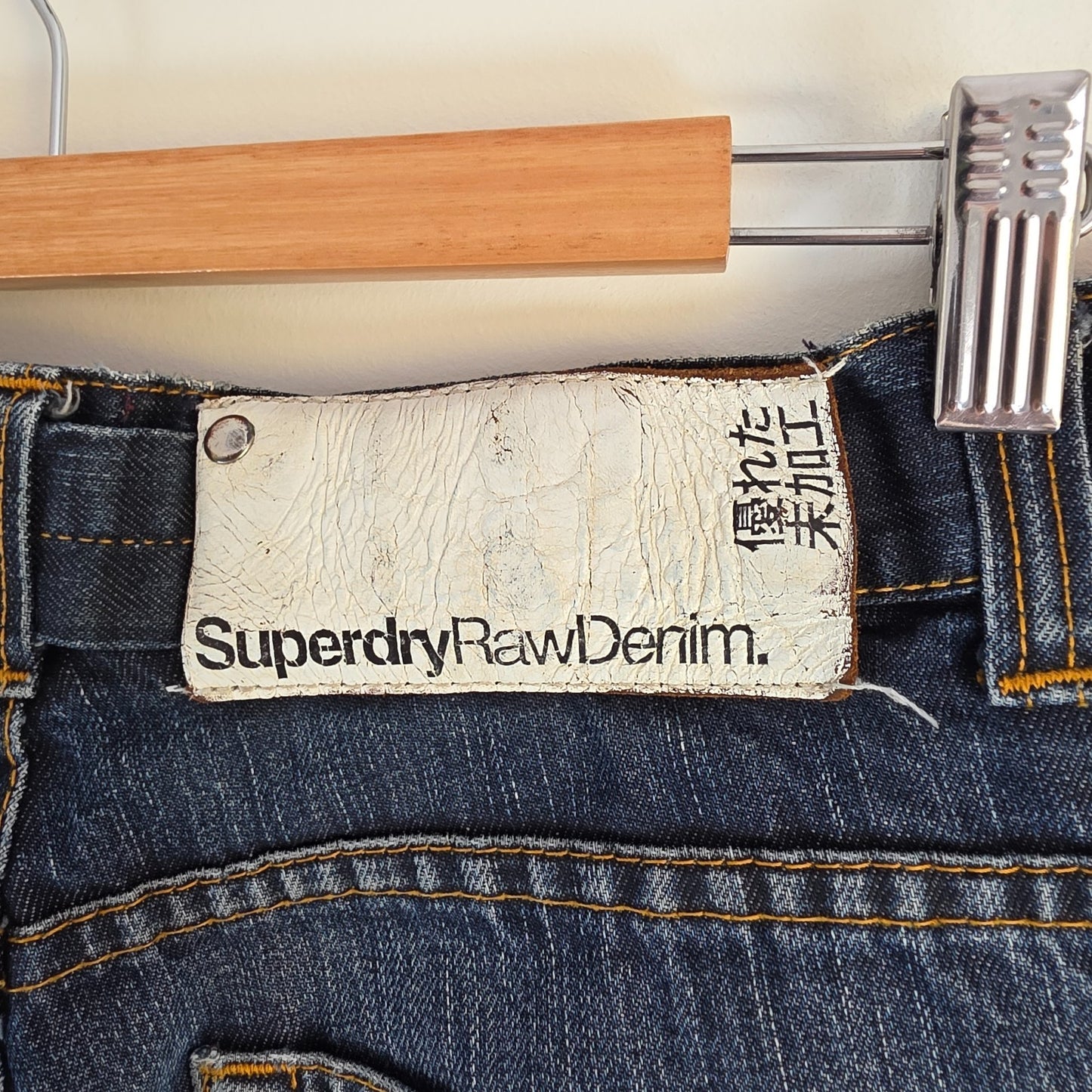 Superdry blue straight jeans with button fly, vintage raw denim, light wear.