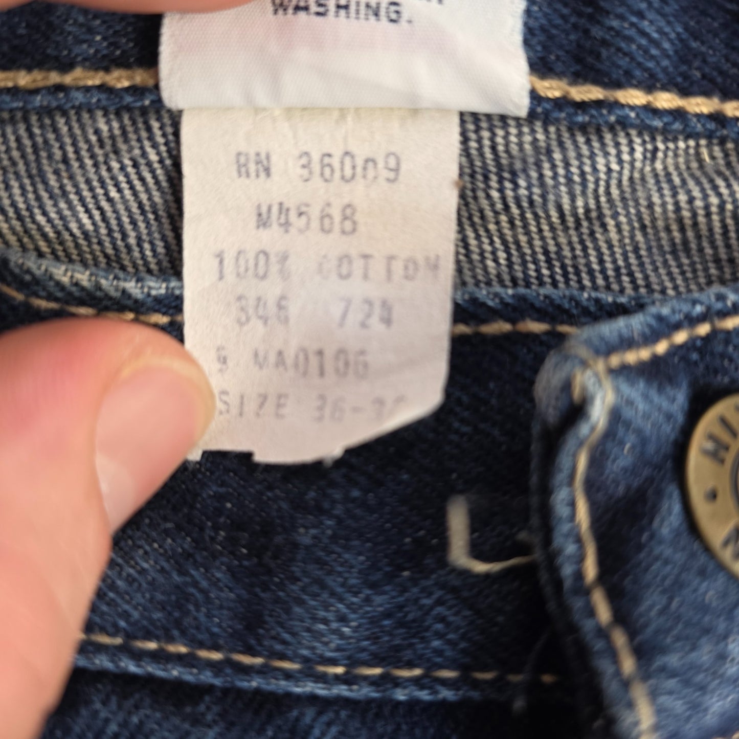 Calvin Klein blue straight leg jeans with vintage 90s style and cotton material.