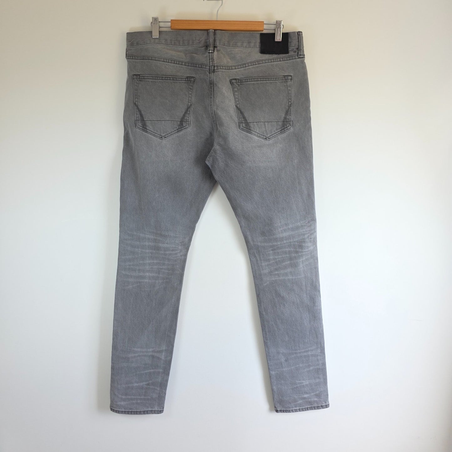 AllSaints grey slim jeans with button fly and stretch cotton elastane blend.