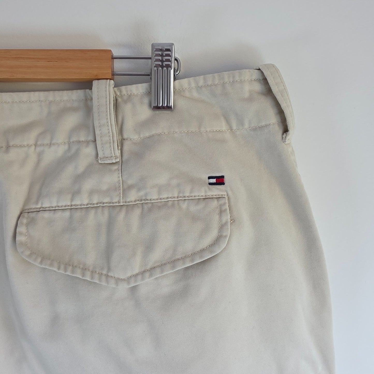 Tommy Hilfiger beige cargo shorts with utility pockets and cotton material.