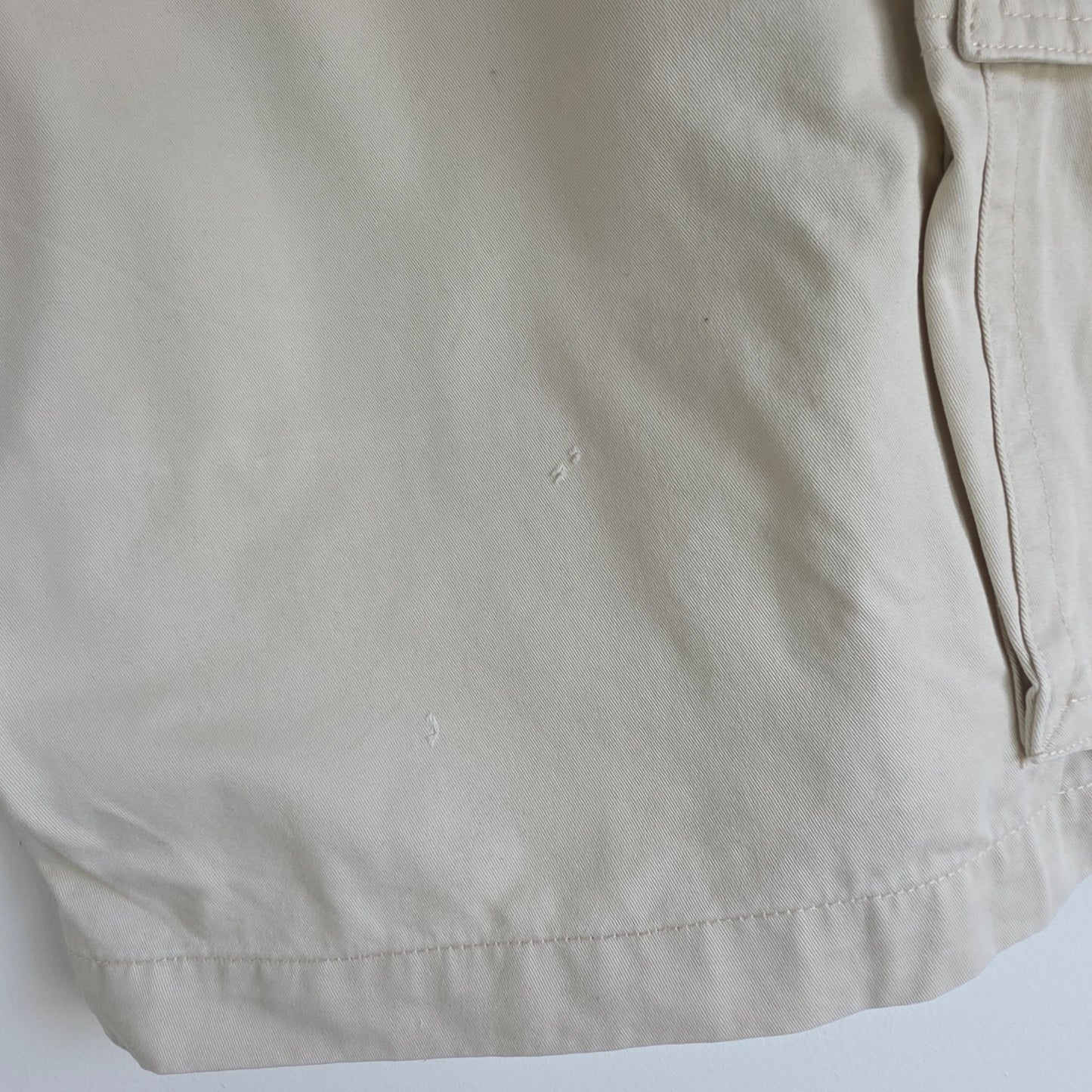 Tommy Hilfiger beige cargo shorts with utility pockets and cotton material.