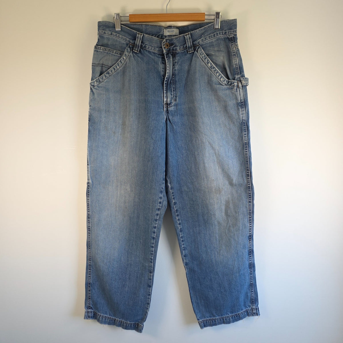 Old Navy blue carpenter jeans with hammer loop and utility pocket detailing.