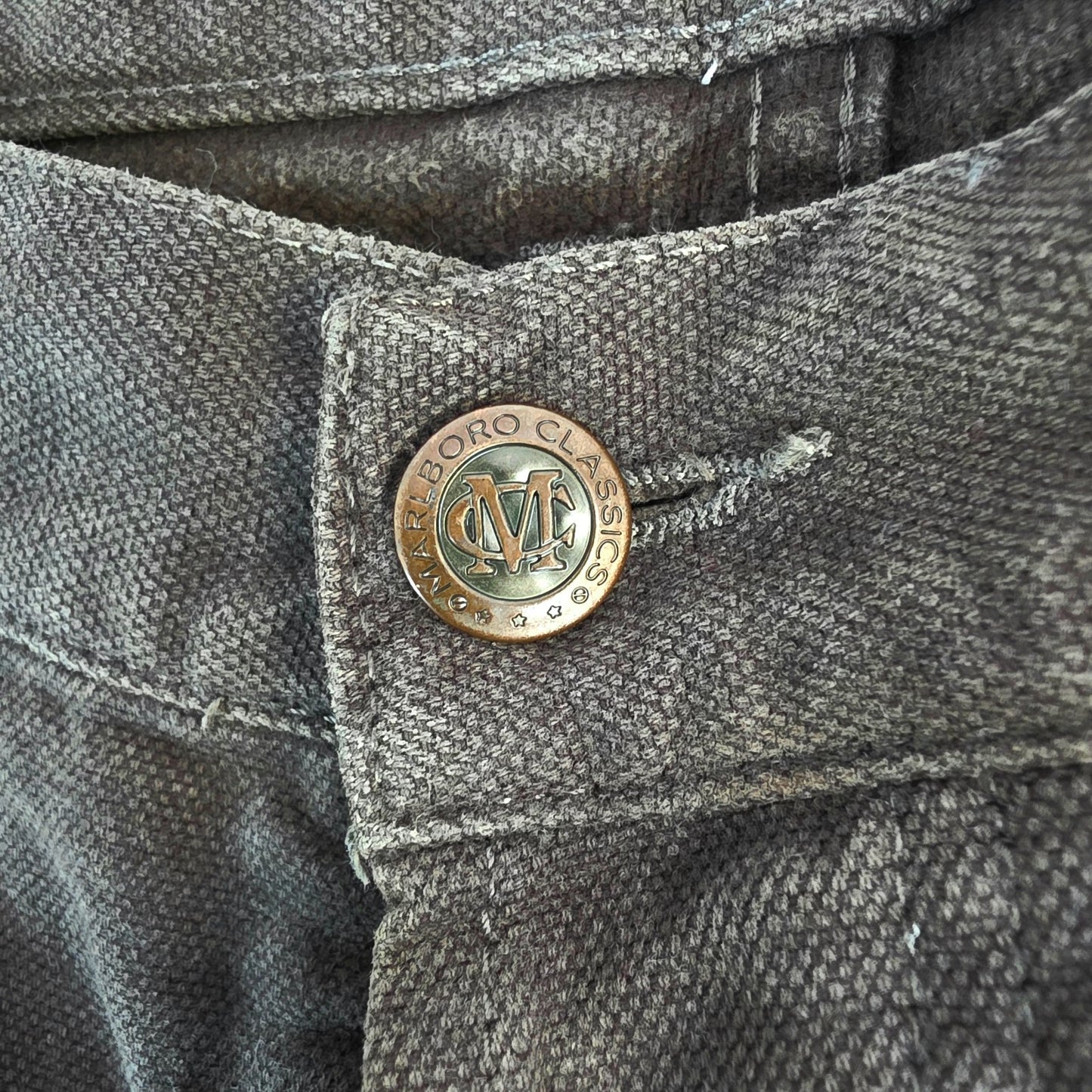 Marlboro Classics grey straight jeans with button fly and vintage logo detail.