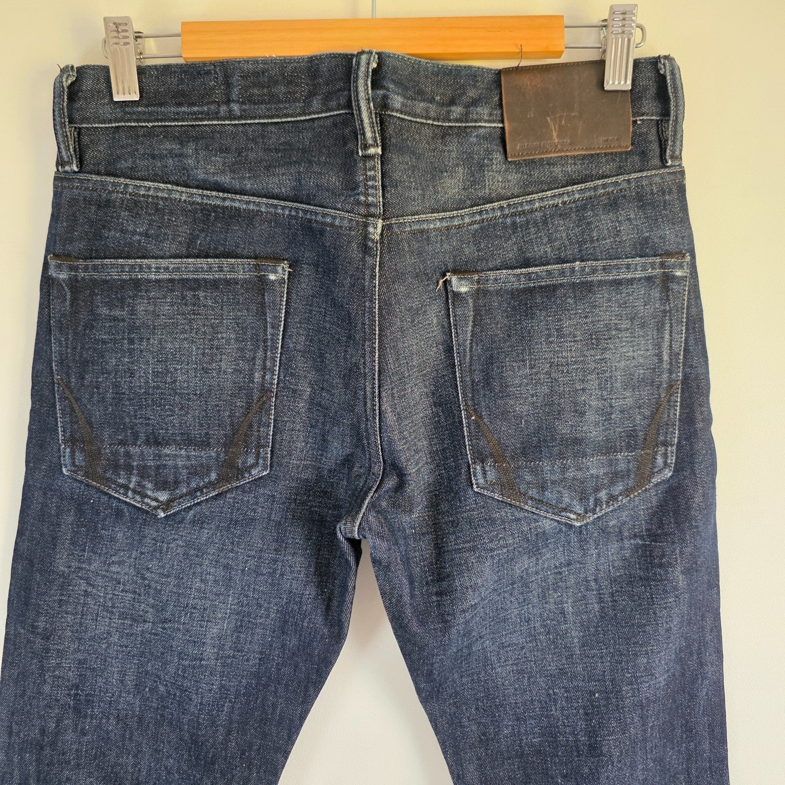 AllSaints blue straight jeans dark wash denim with subtle fading and slim fit.