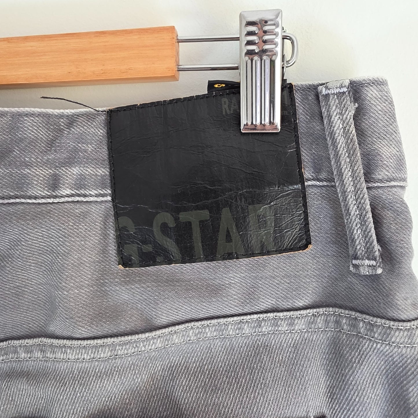 G-Star grey straight jeans with biker style detailing and subtle wear at the hem.