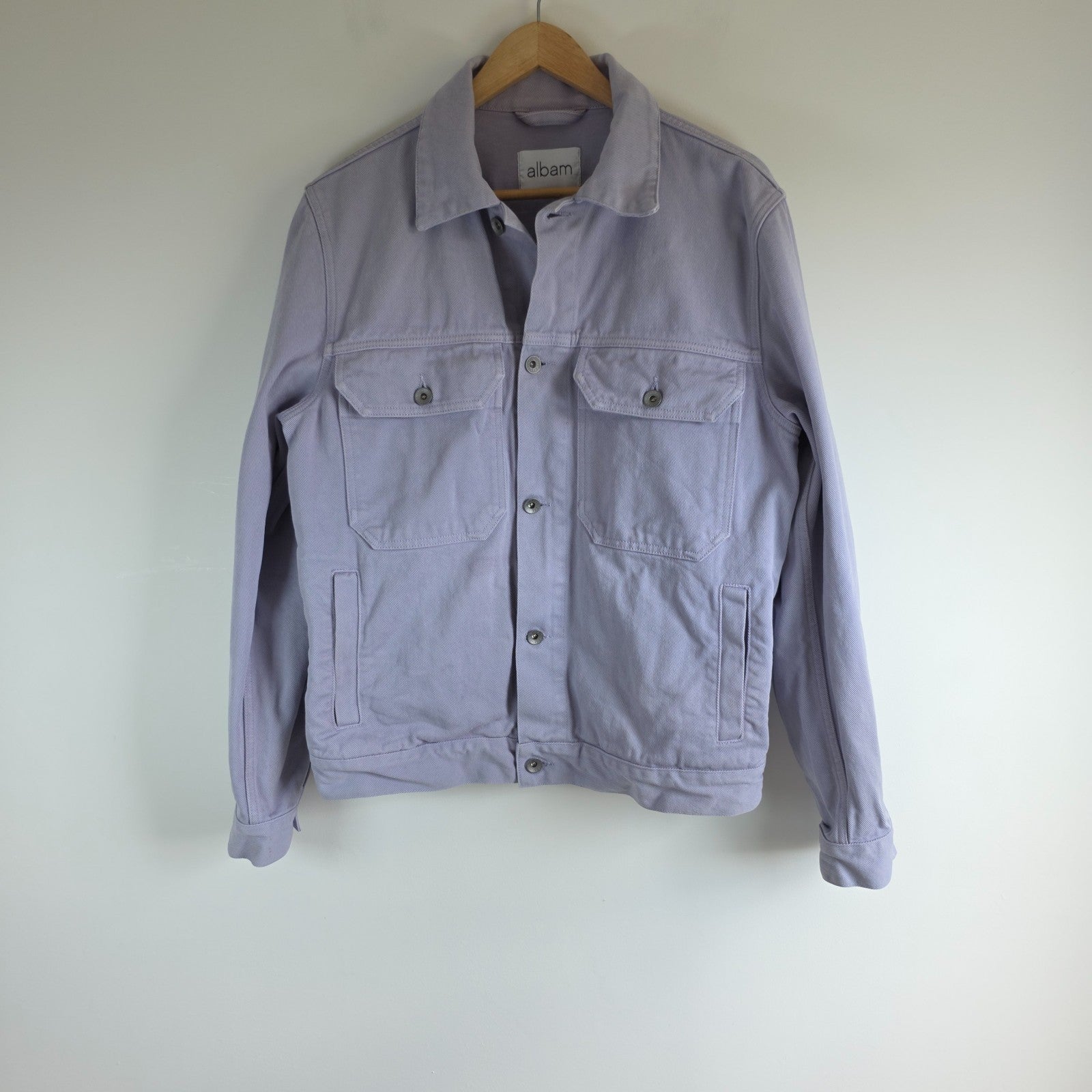 Albam lilac denim jacket with button front, chest pockets, and side pockets.