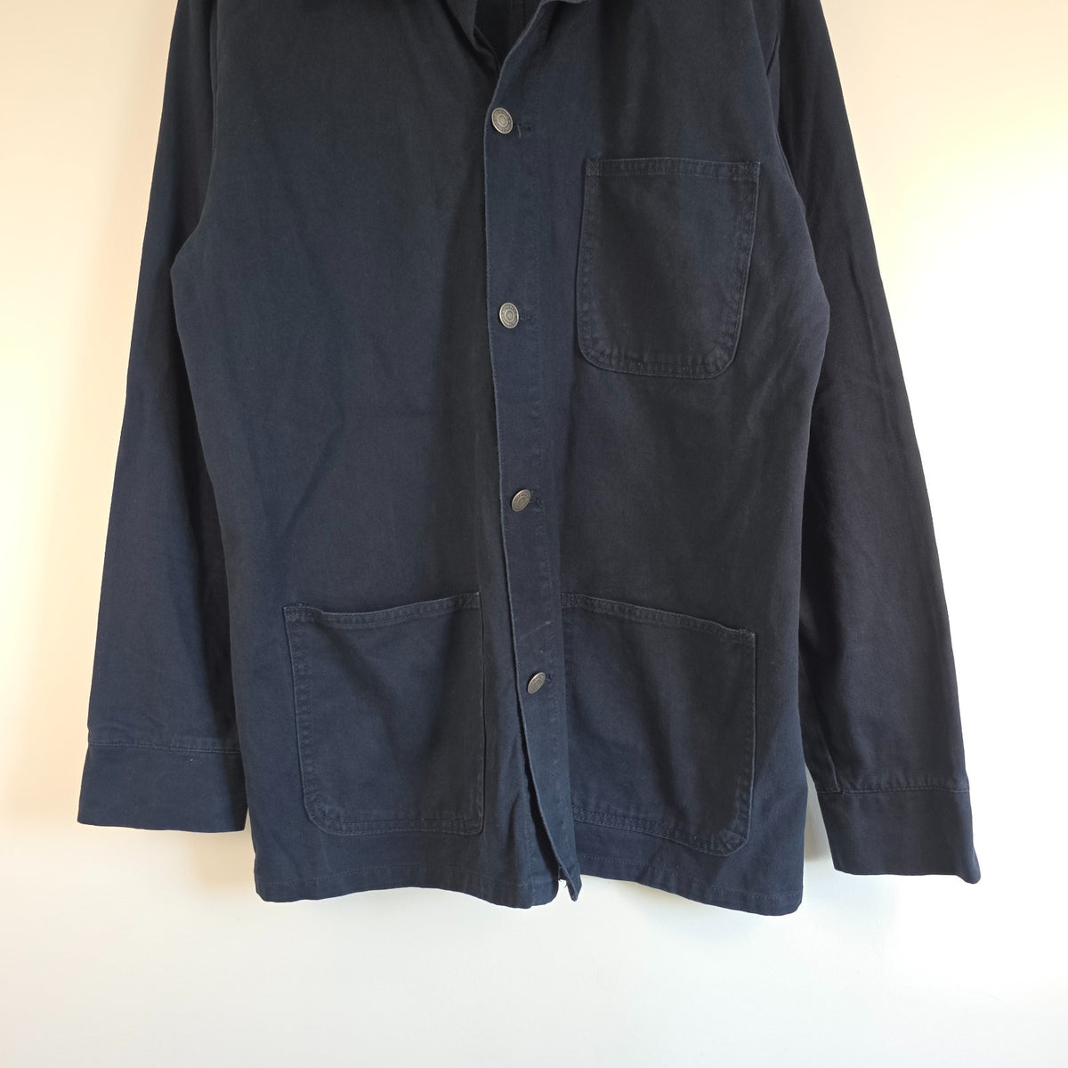 French Connection blue chore jacket with three patch pockets and metal button fastening.