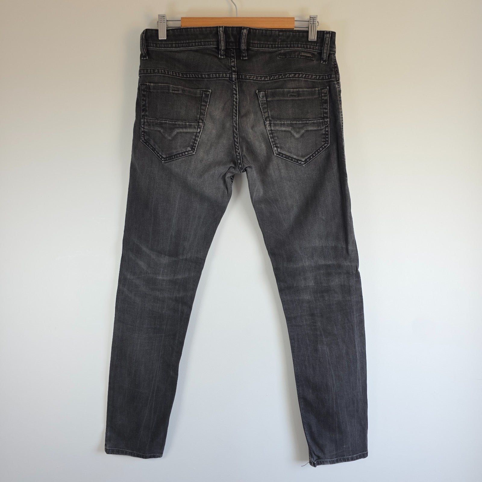 Diesel black straight jeans with grey wash, stretch denim, and branded tag.
