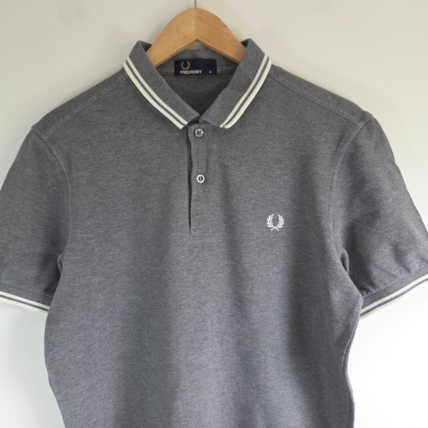Fred Perry grey polo shirt with white twin tipping and classic laurel logo.