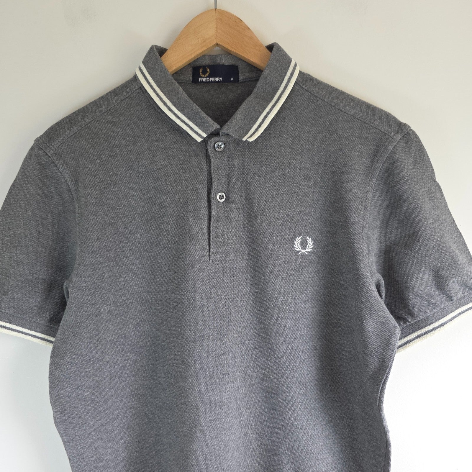 Fred Perry grey polo shirt with white twin tipping and classic laurel logo.