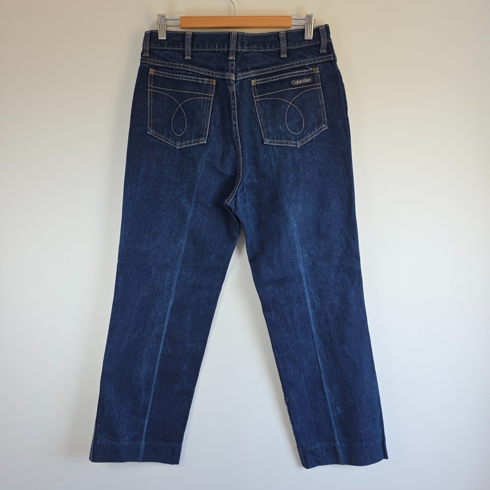 Calvin Klein blue straight leg jeans with vintage 90s style and cotton material.