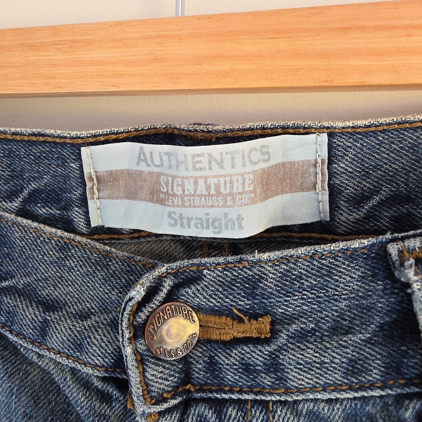 Levi's blue straight leg jeans, cotton material, missing back waist patch, casual style.