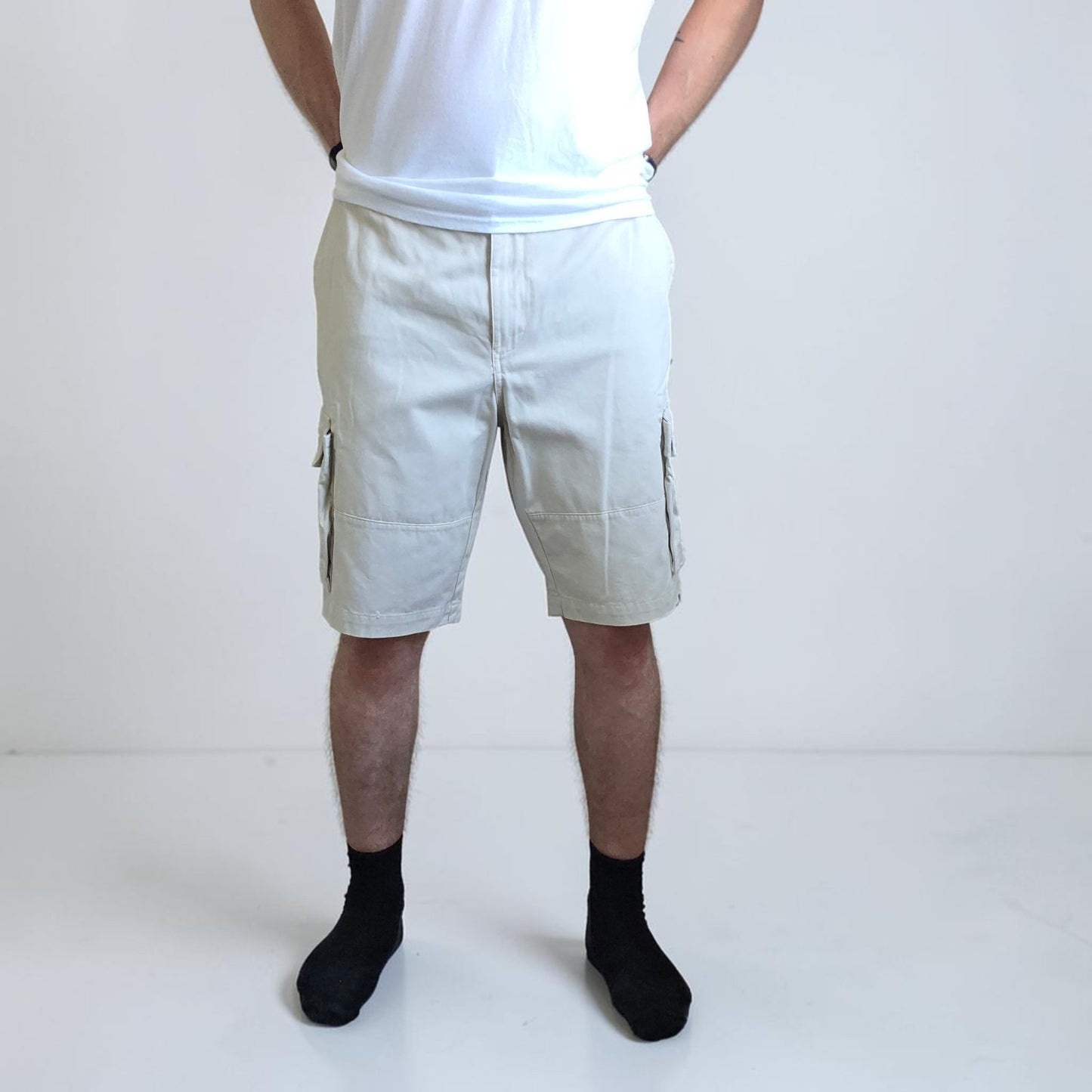 Tommy Hilfiger beige cargo shorts with utility pockets and cotton material.