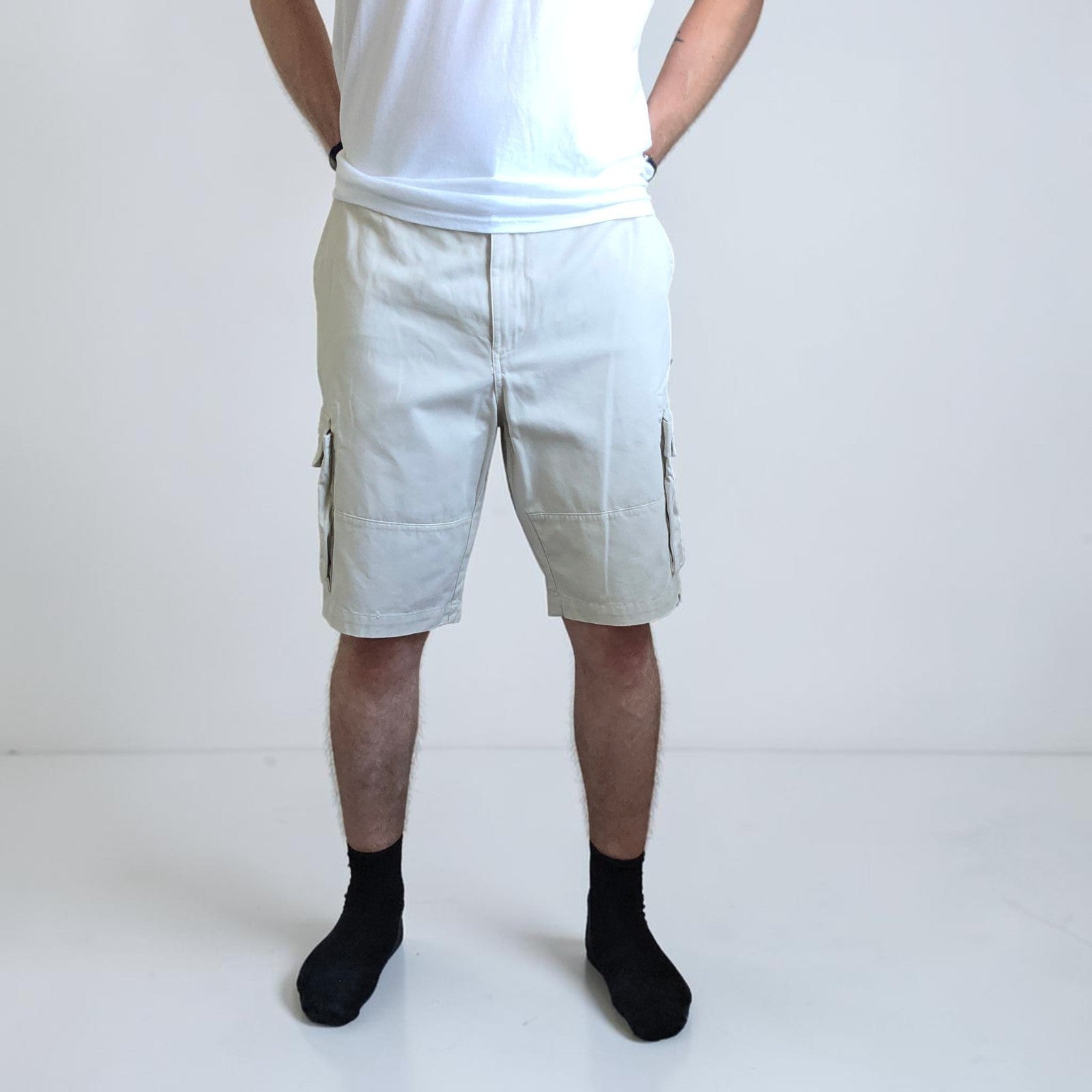 Tommy Hilfiger beige cargo shorts with utility pockets and cotton material.