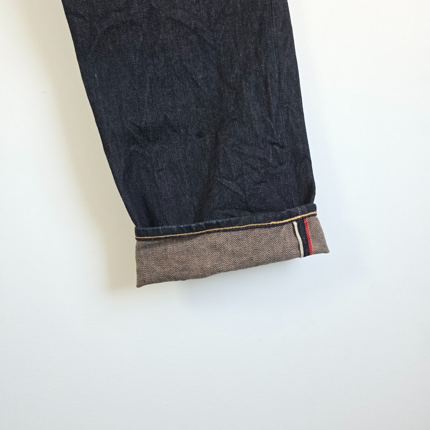 Evisu blue straight jeans with selvedge denim and button fly detailing.