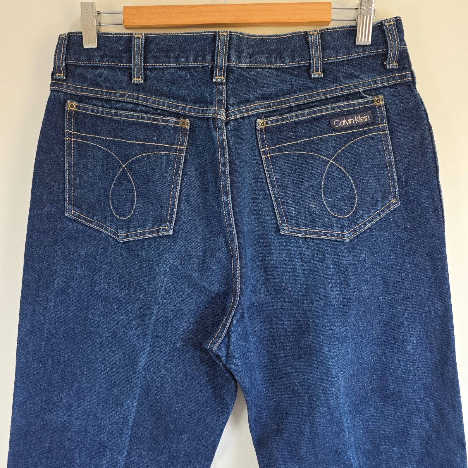 Calvin Klein blue straight leg jeans with vintage 90s style and cotton material.
