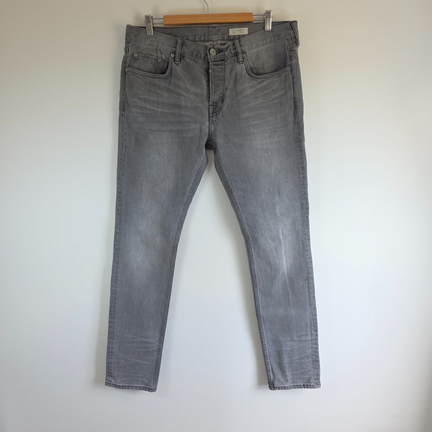 AllSaints grey slim jeans with button fly and stretch cotton elastane blend.