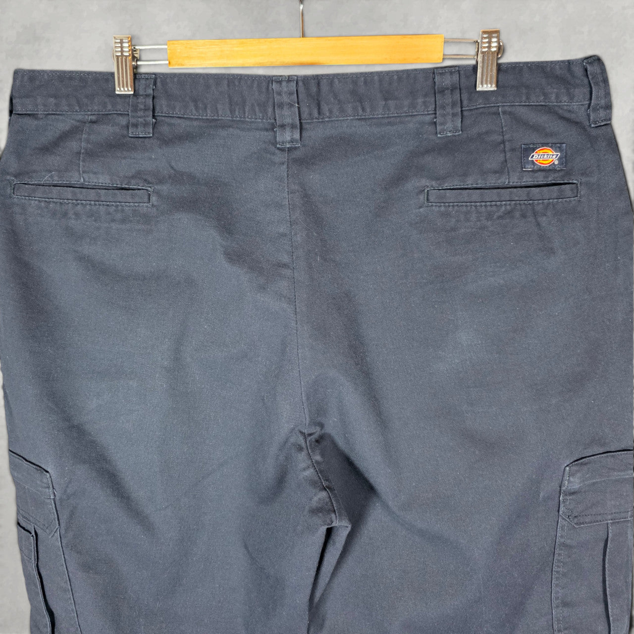 Dickies blue cargo trousers with zipped pockets and relaxed fit, made from durable flex fabric.