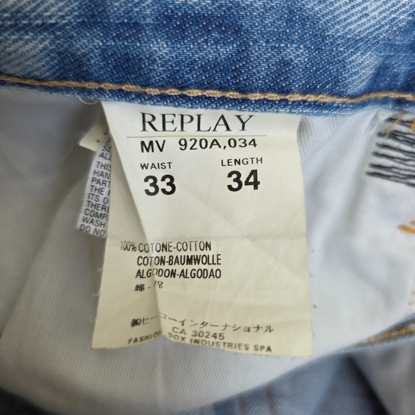 Replay blue straight jeans with button fly and light distressed pocket detailing.