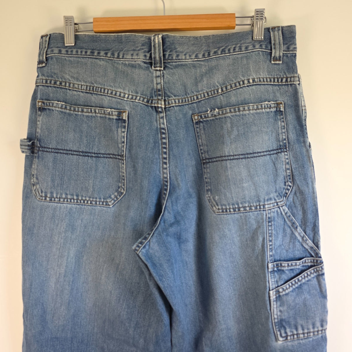 Old Navy blue carpenter jeans with hammer loop and utility pocket detailing.