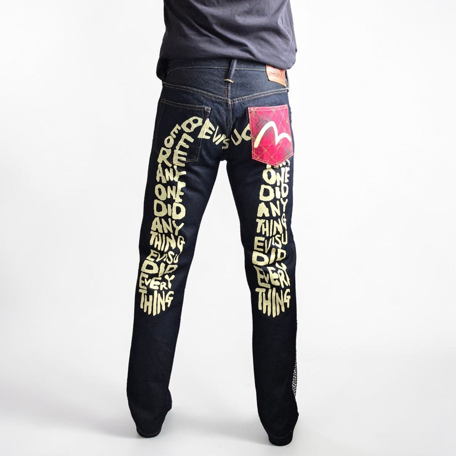 Evisu blue straight jeans with selvedge denim and button fly detailing.