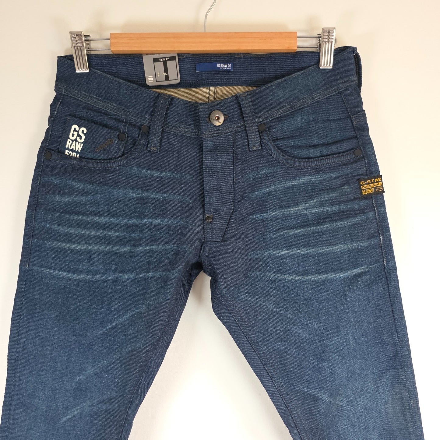 G-Star blue straight jeans with button fly and BNWT tag, cotton elastane blend.