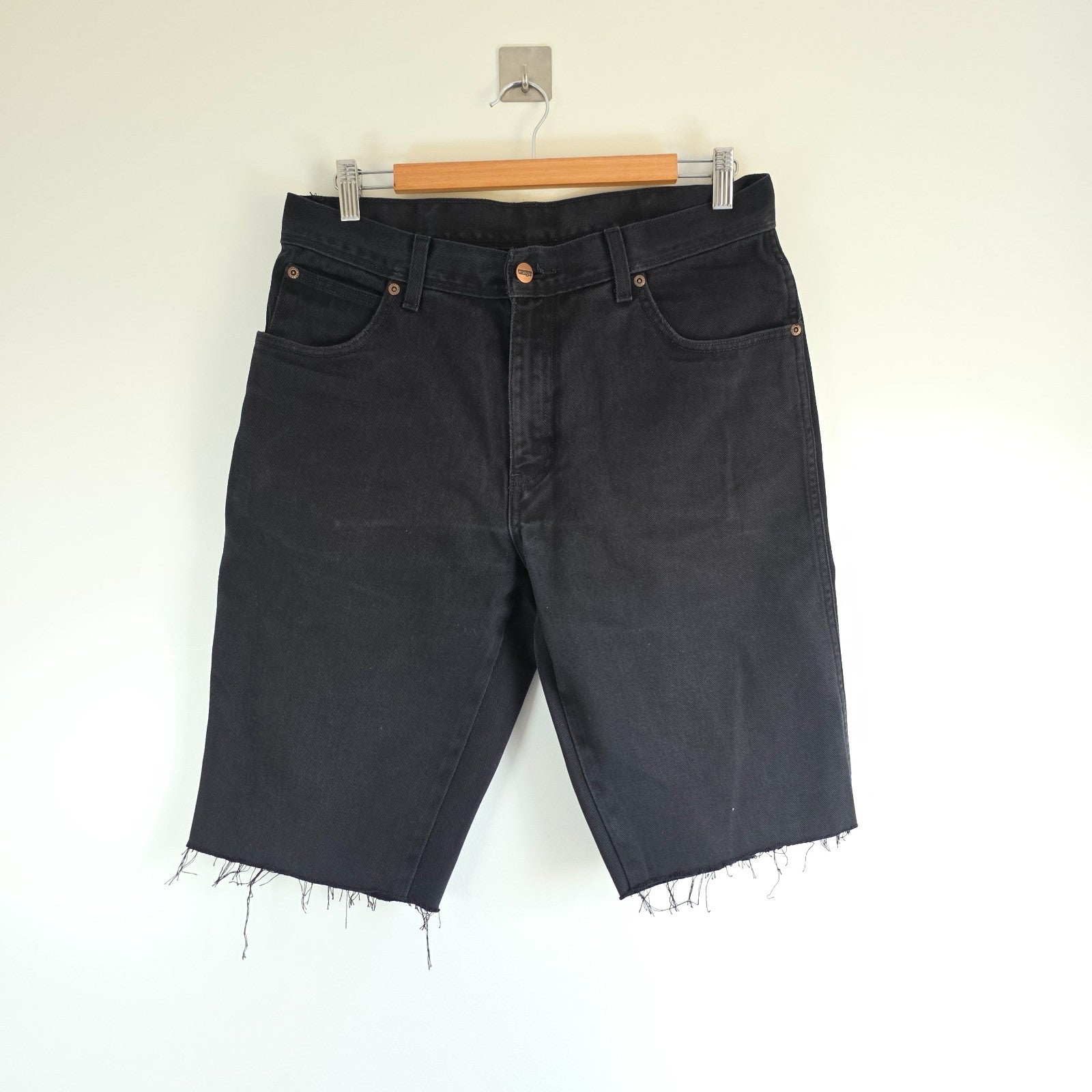 Wrangler black denim shorts W33 with frayed hems and copper-toned button.