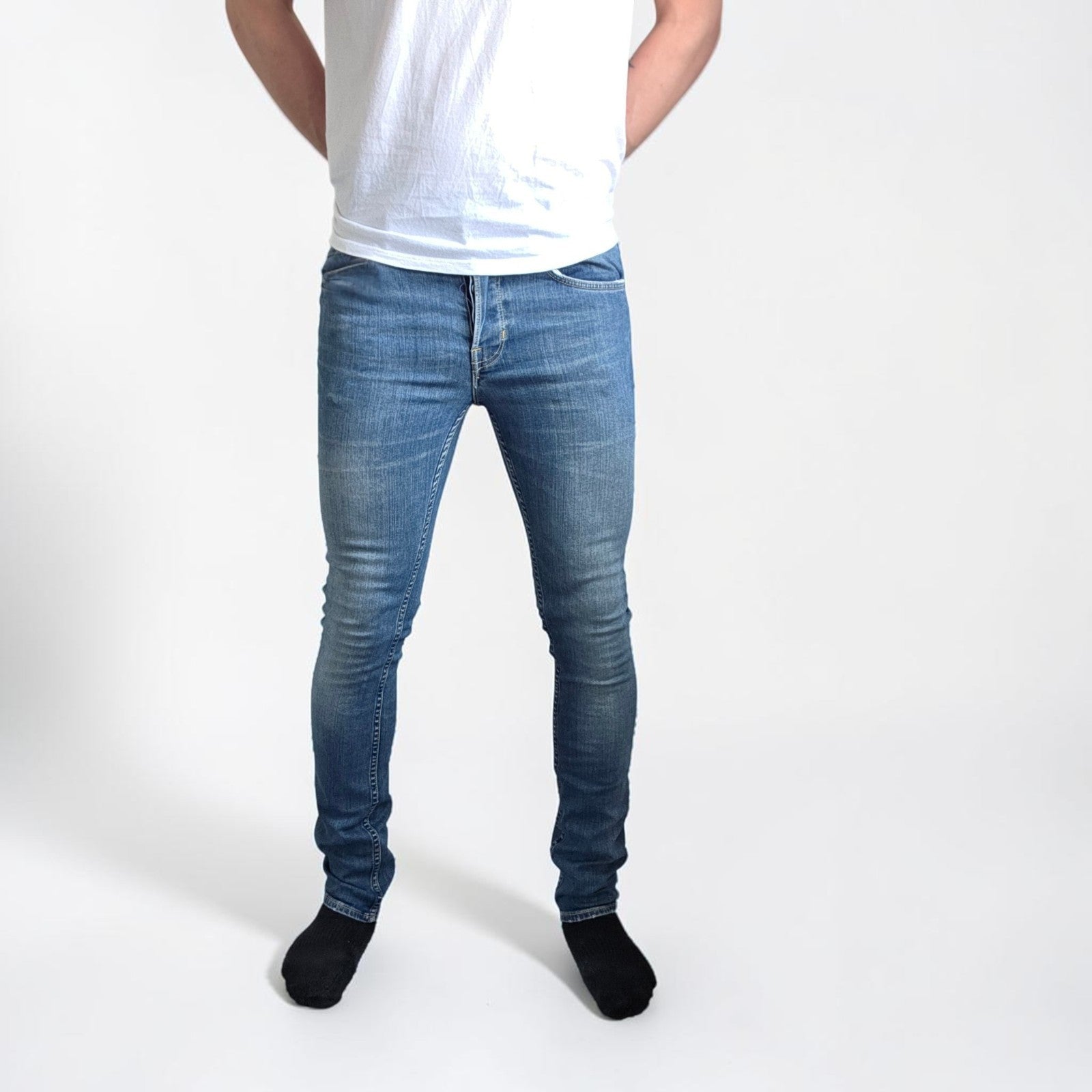 AllSaints blue skinny jeans with faded wash and modern slim fit design.