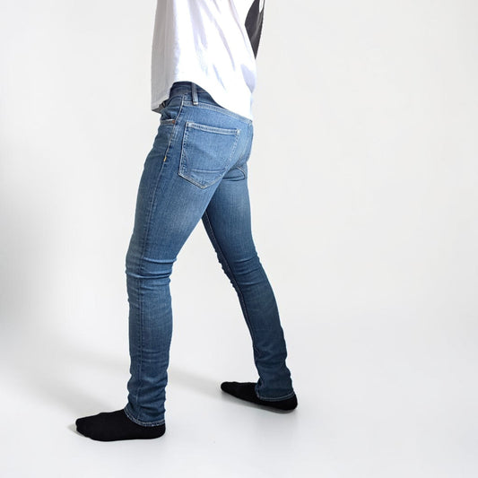 AllSaints blue skinny jeans with faded wash and modern slim fit design.