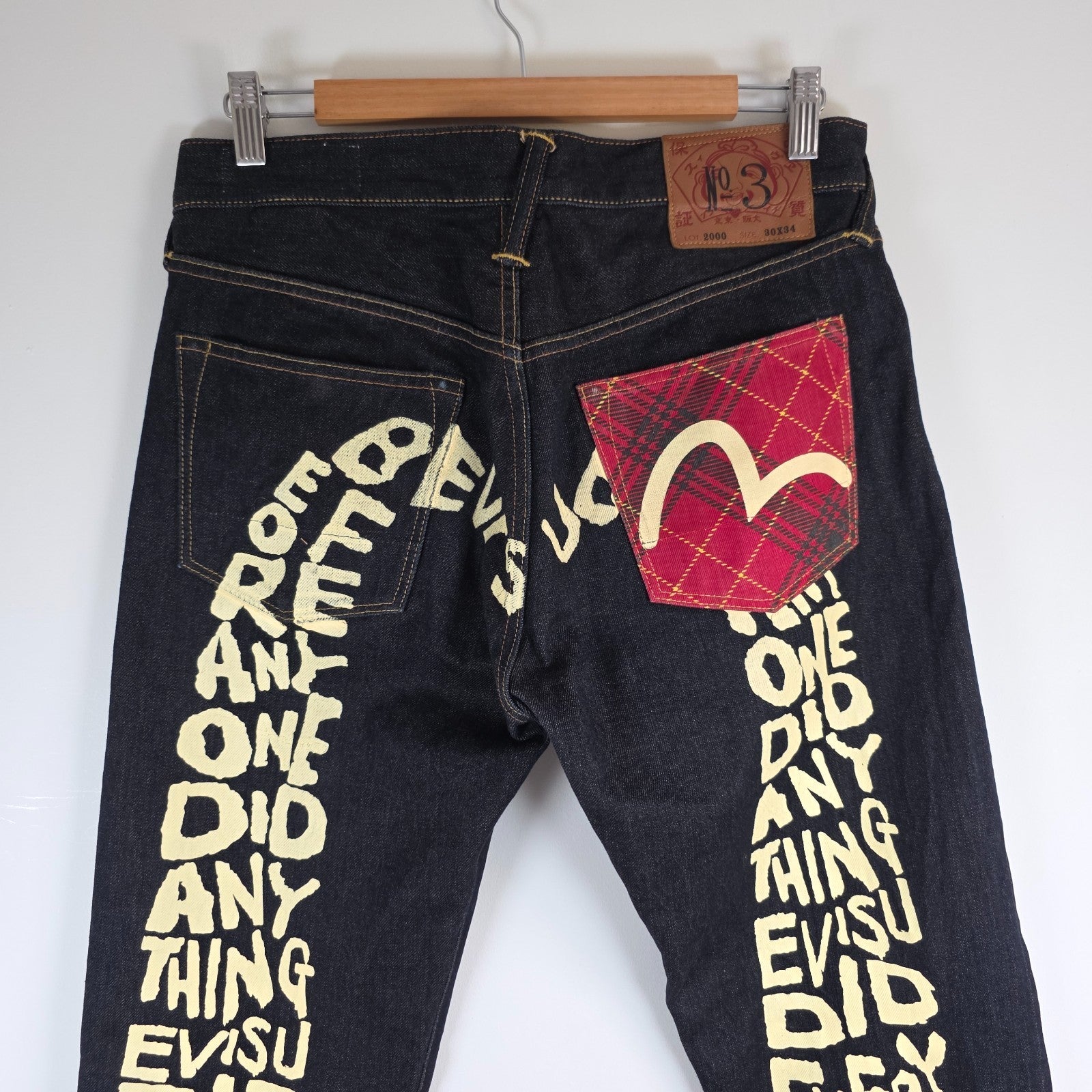 Evisu blue straight jeans with selvedge denim and button fly detailing.