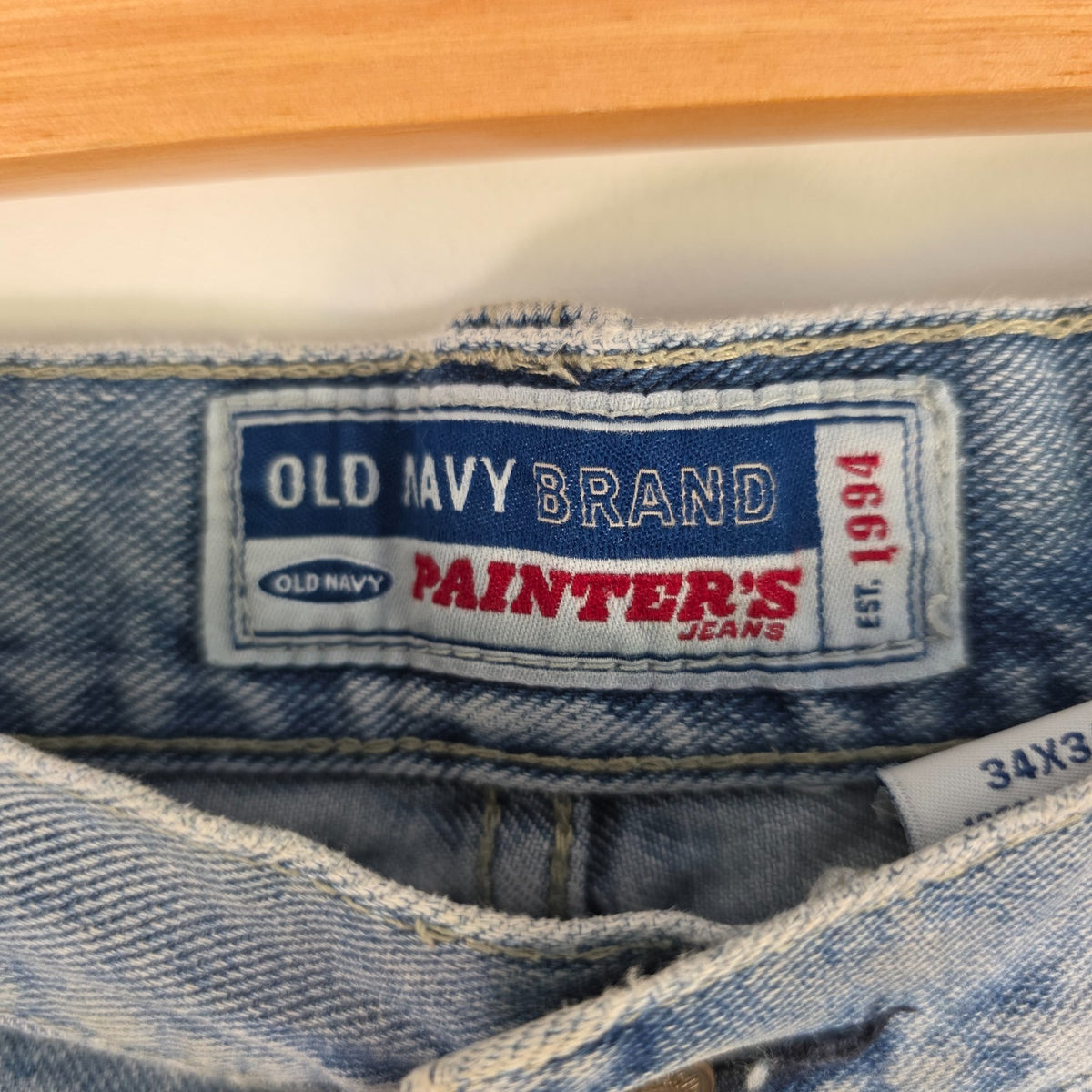 Old Navy blue carpenter jeans with hammer loop and utility pockets, 100% cotton.
