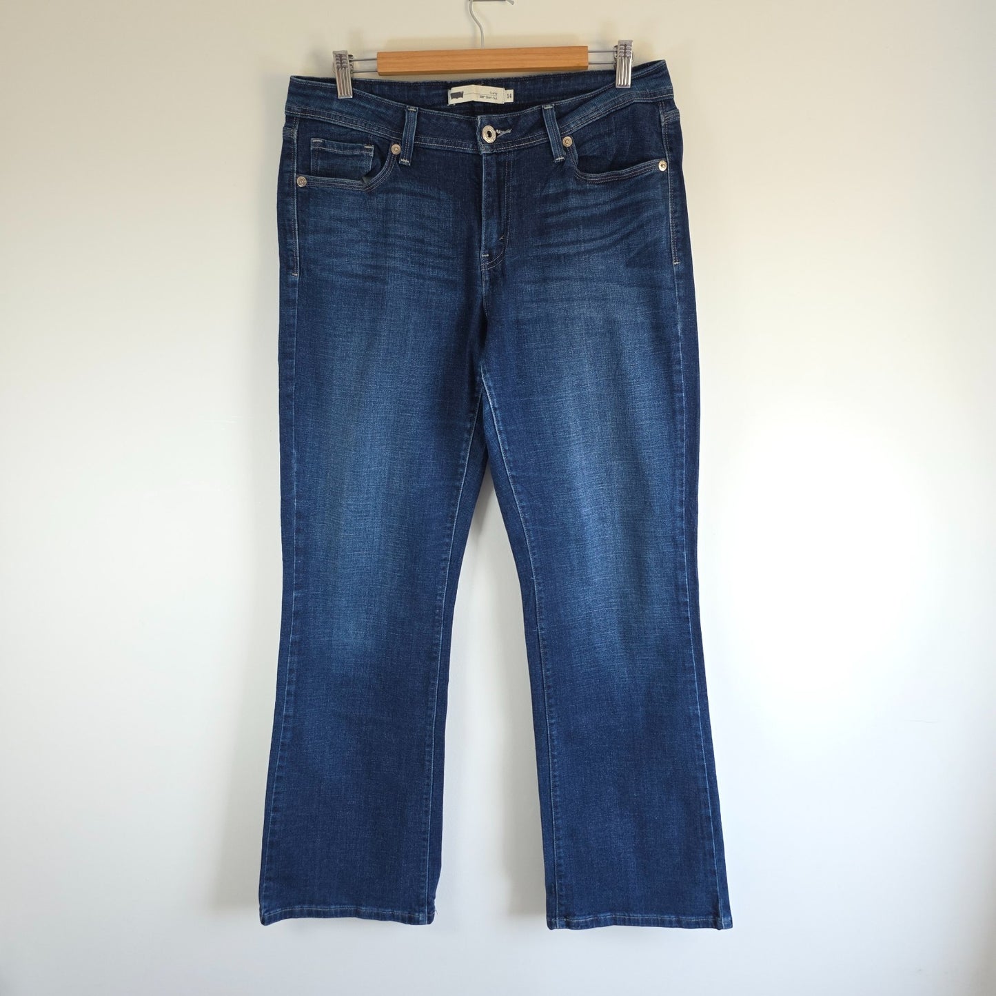 Levi's blue straight jeans with distressed details and classic 501 logo.