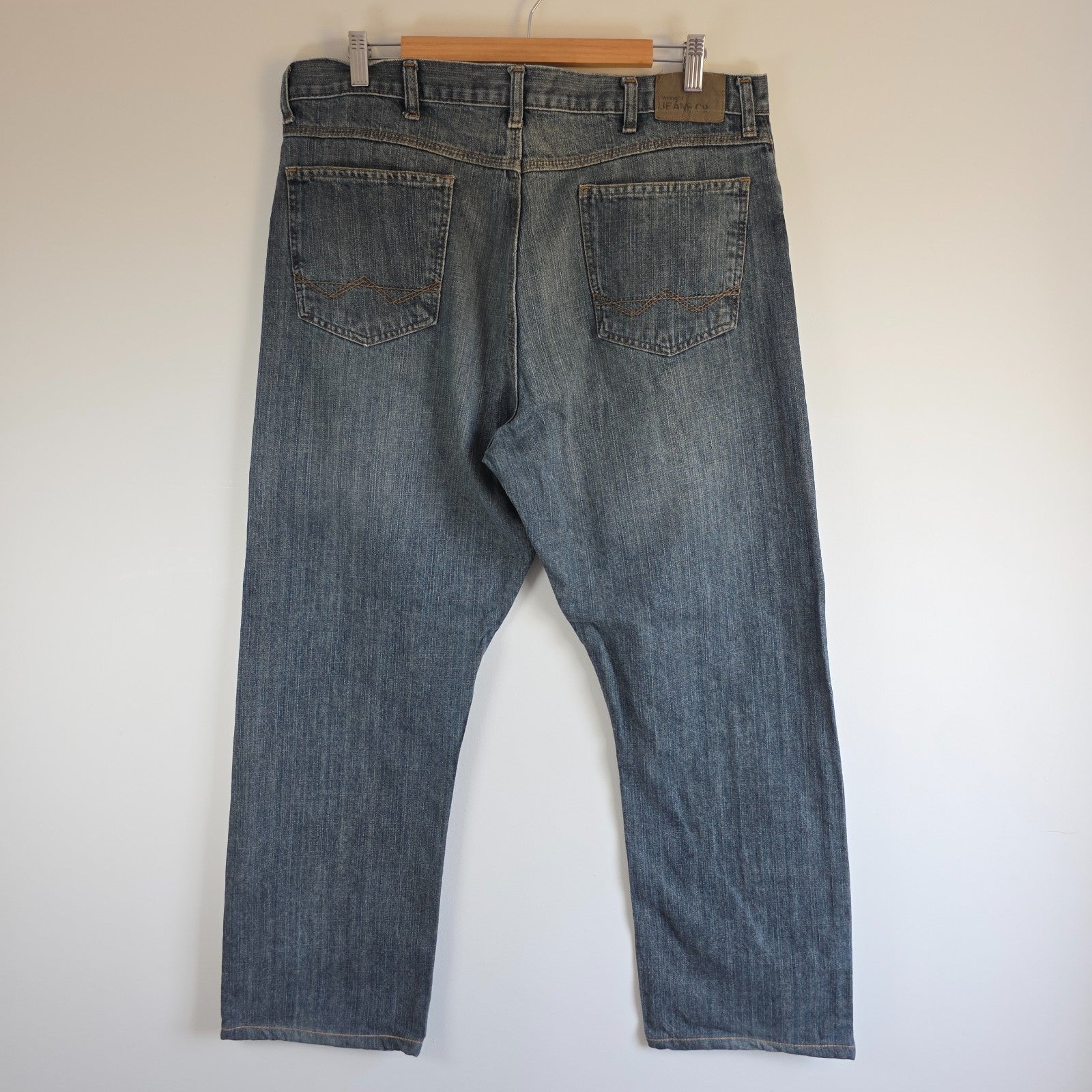 Wrangler blue straight jeans with relaxed fit, 100% cotton, professional hemmed to 30 inches.