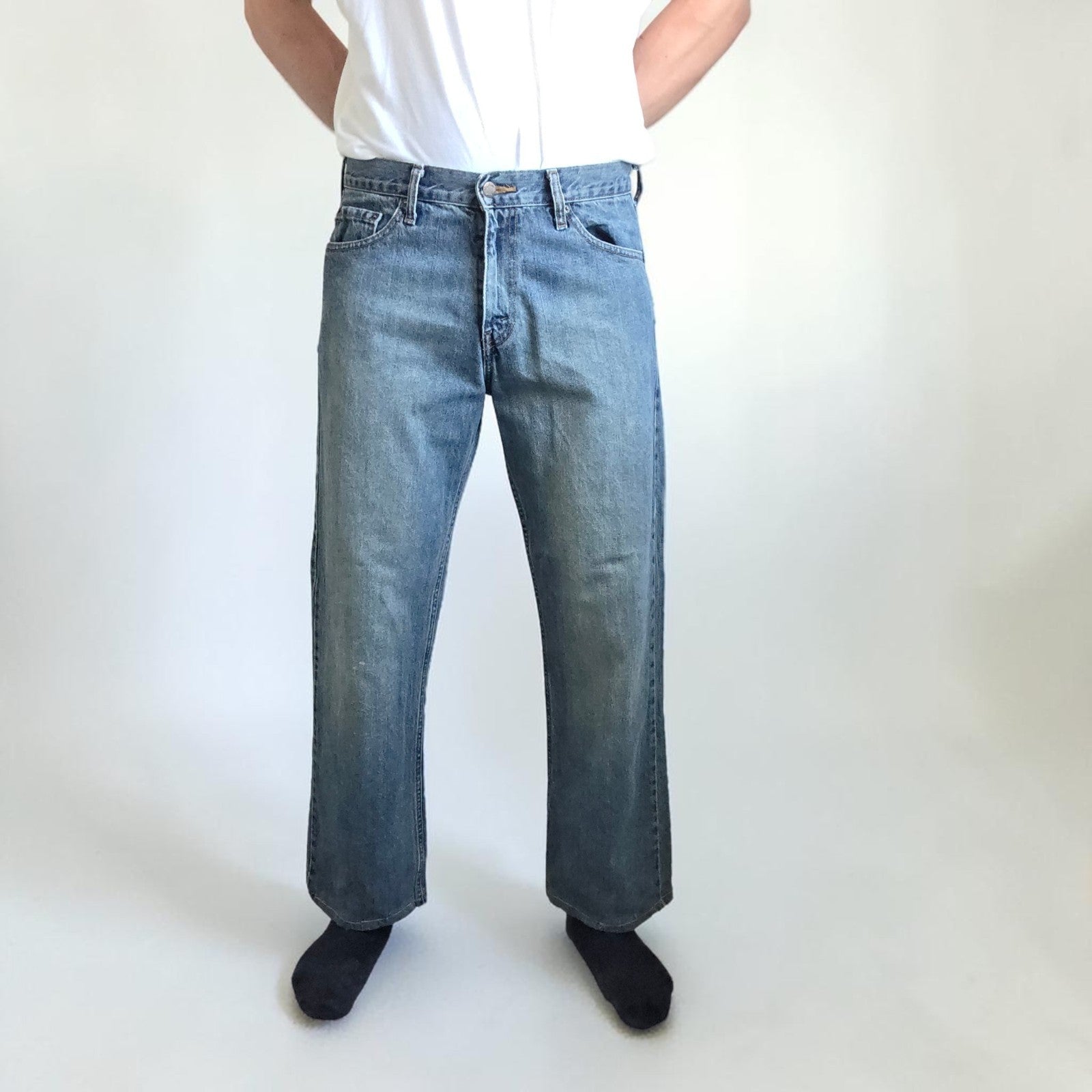 Levi's blue straight leg jeans, cotton material, missing back waist patch, casual style.